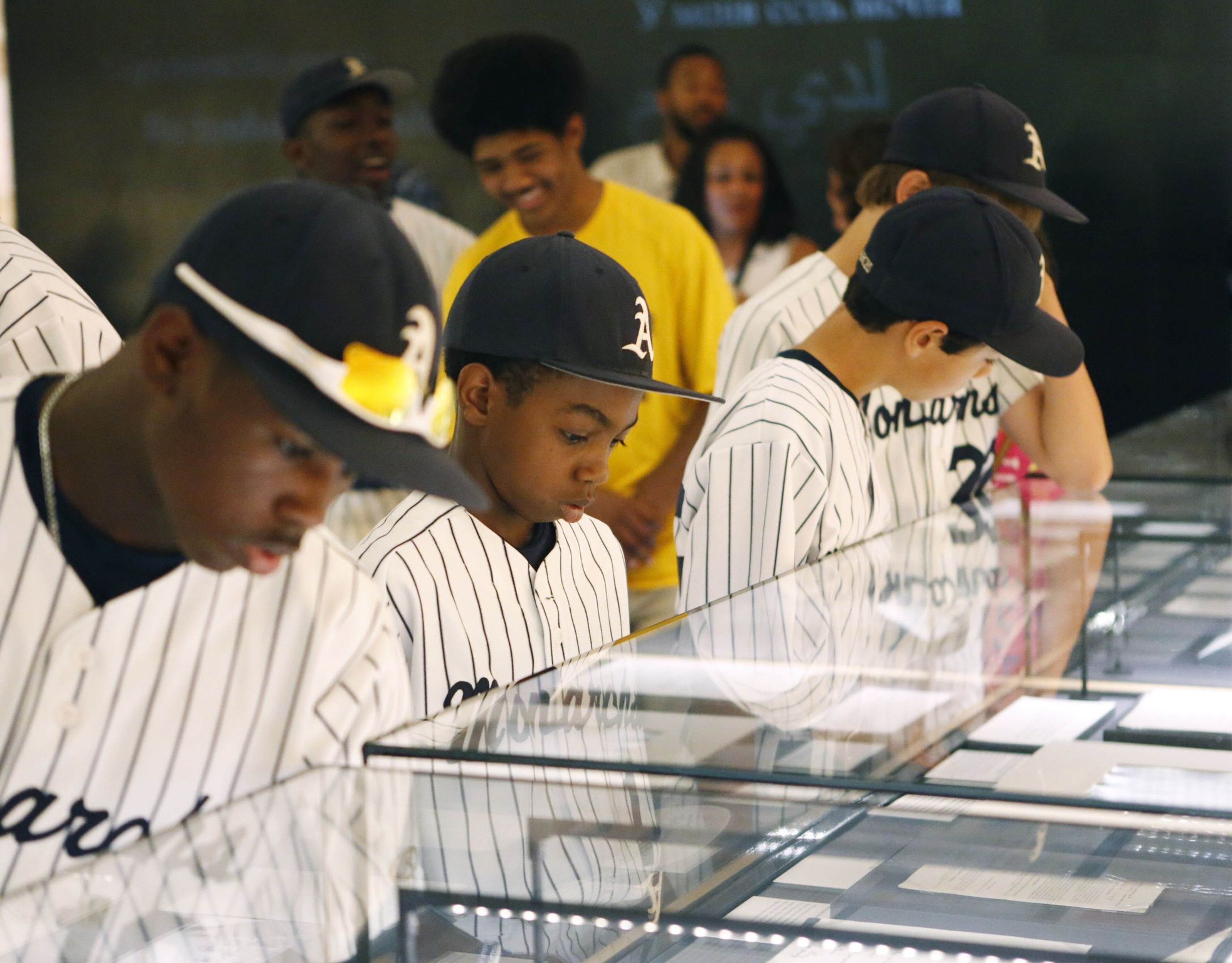 Jahli Hendricks (from left), Nasir Jackson and Jack Rice look over some of the Rev. Martin Luther King Jr.'s papers at the National Center for Civil and Human Rights in Atlanta in 2015. The boys were members of a Little League baseball team from Philadelphia making a 23-day civil rights tour through the South. (Bob Andres/AJC 2015)