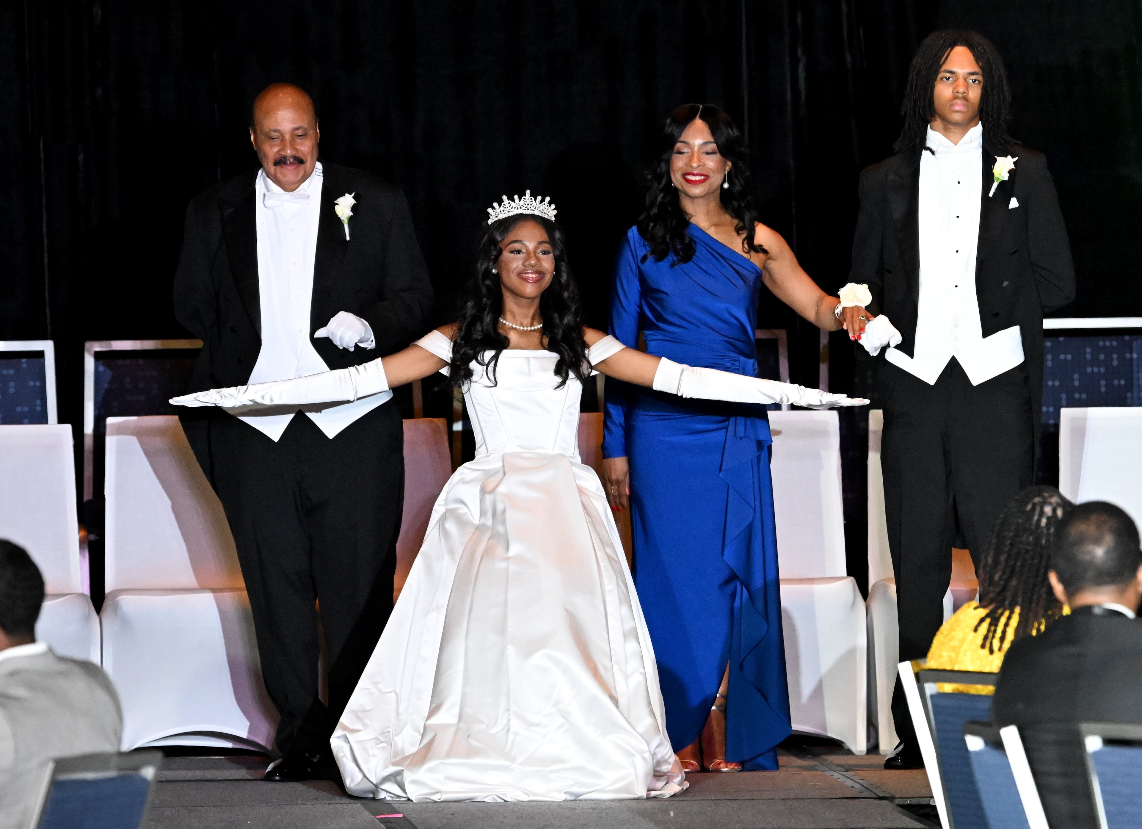 Debutante Yolanda Renee King is recognized as her parents, Arndrea and Martin Luther King III, and junior escort Brandon Coleman stand behind her during the 2026 Pink Cultured Pearls Cotillion. (Hyosub Shin/AJC)