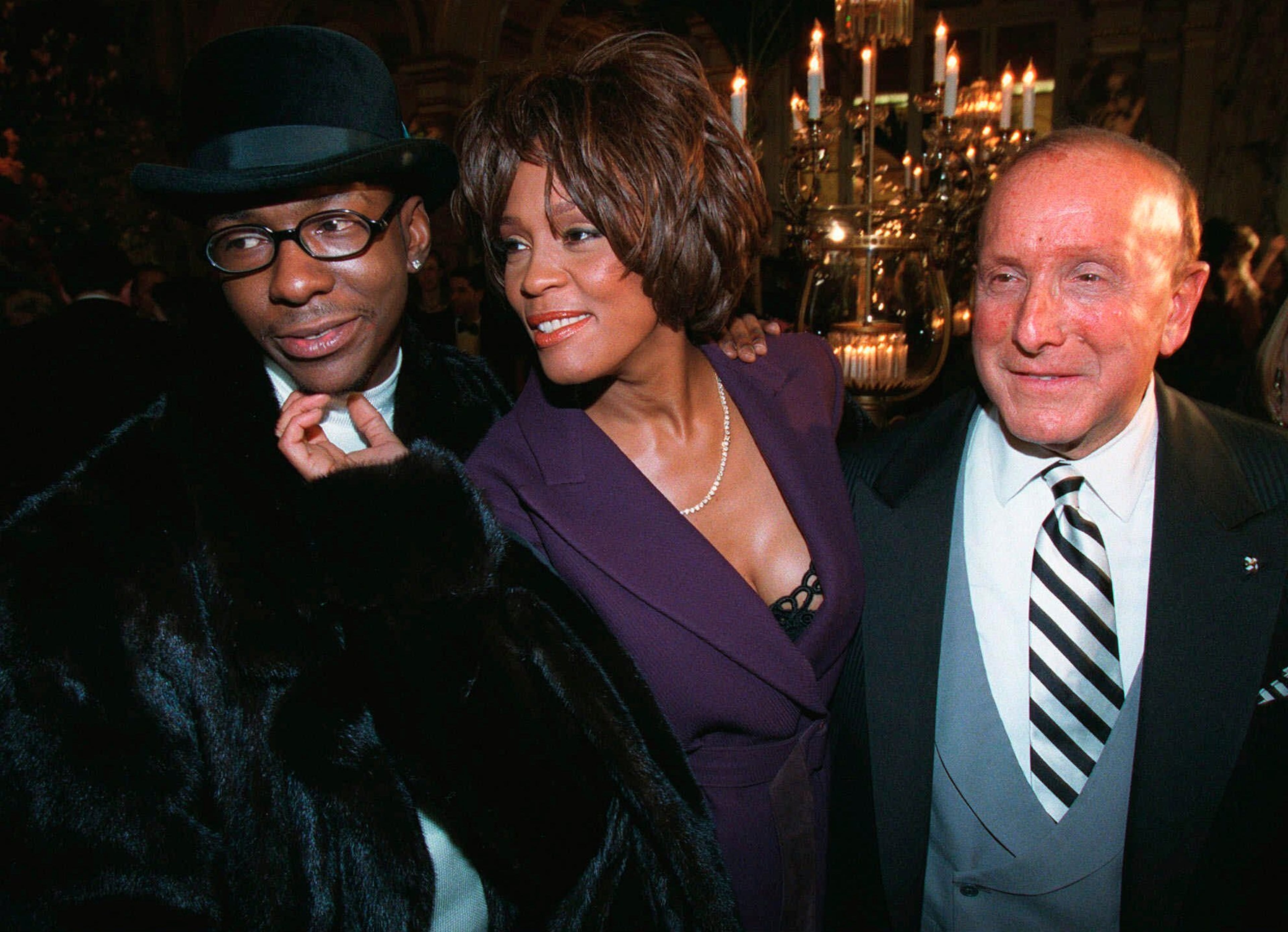 Music producer Clive Davis (right) with Whitney Houston (center) and Bobby Brown in 1998. (Stuart Ramson/AP 1998)