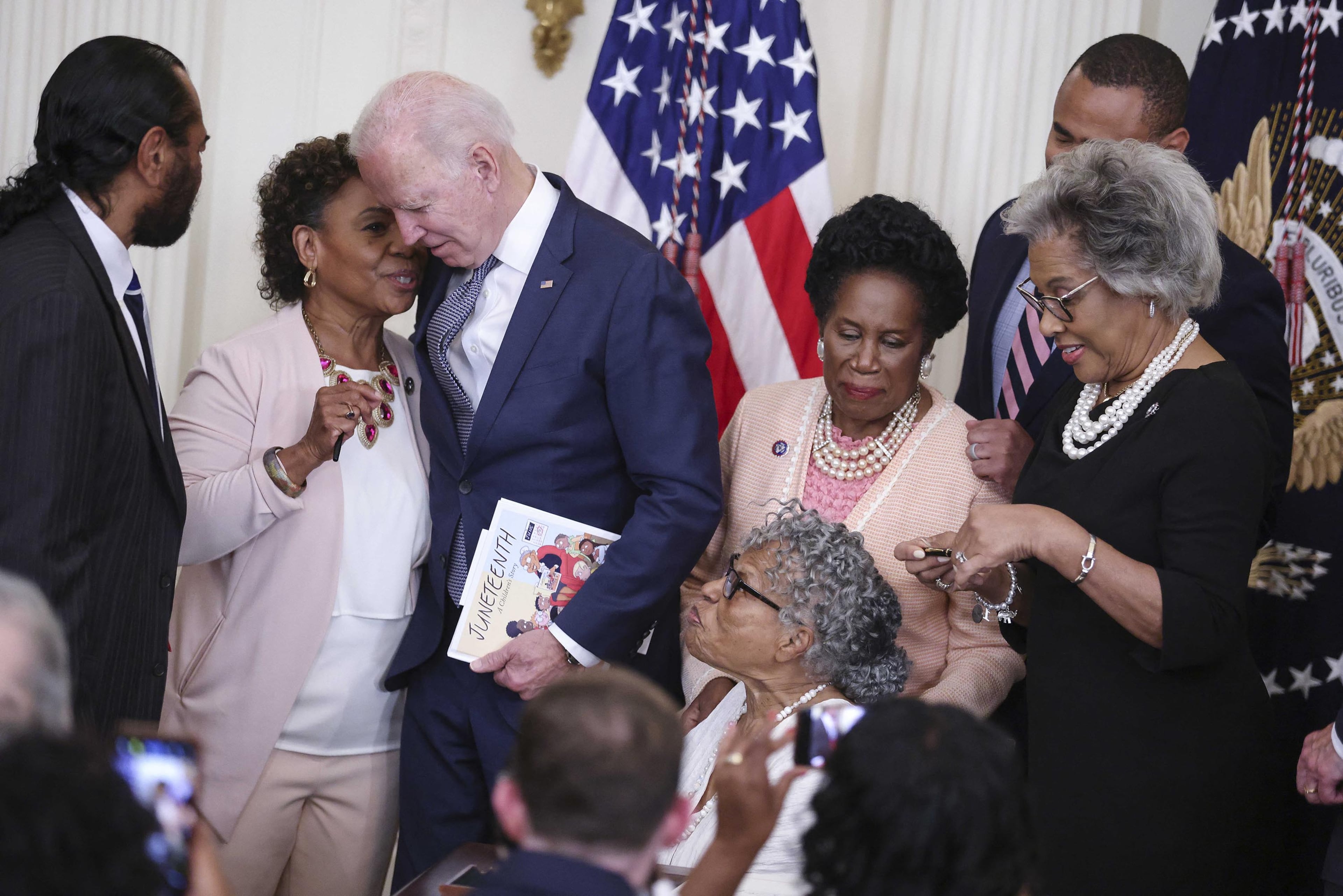 President Joe Biden, third from left, talks to Rep. Barbara Lee, D-Calif., after signing the Juneteenth National Independence Day Act into law in the East Room of the White House on June 17, 2021, in Washington, D.C. (Oliver Contreras/Pool/Abaca Press/TNS)