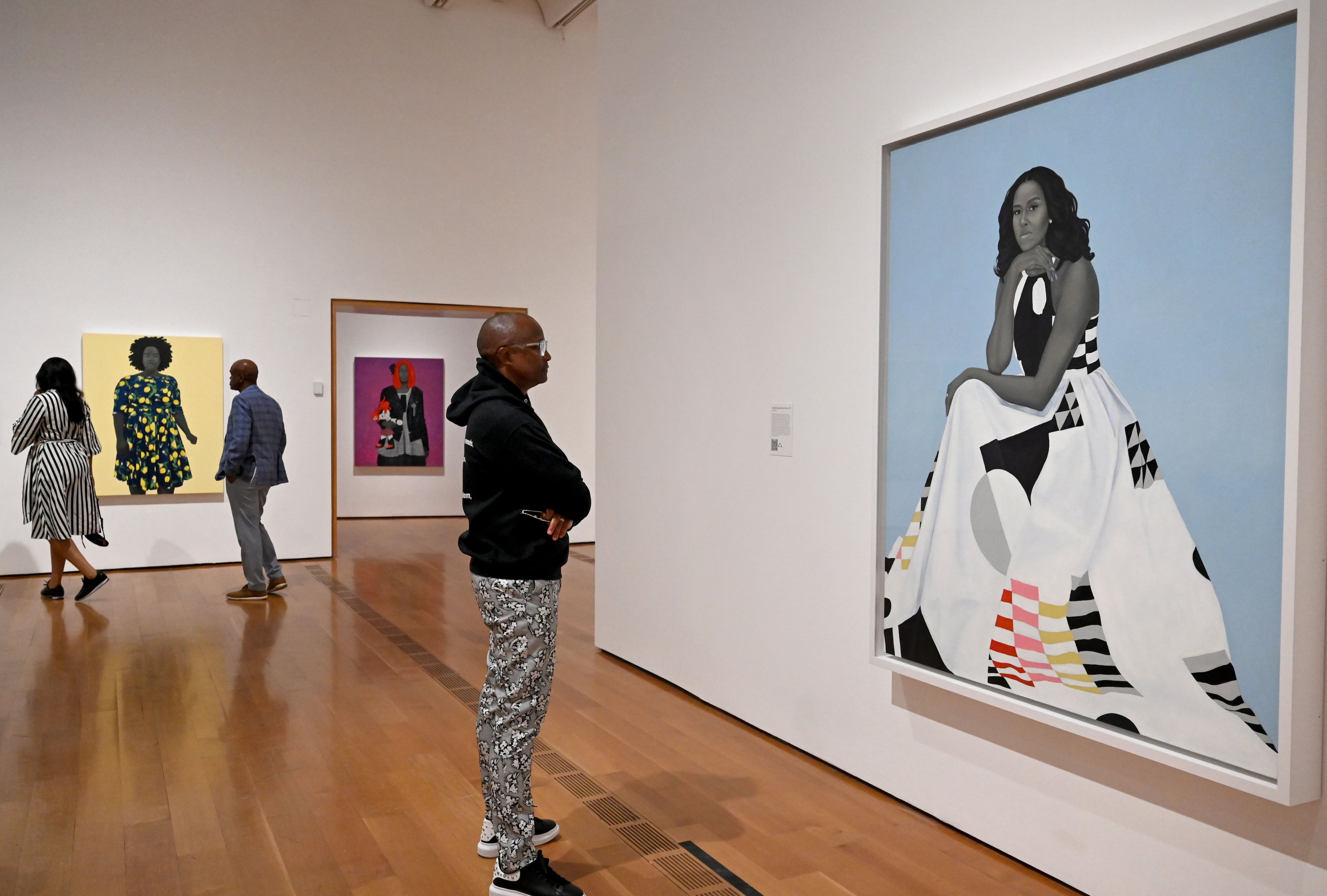 A visitor contemplates the famous “Michelle Obama” portrait in the “American Sublime” exhibition. (Hyosub Shin/AJC)