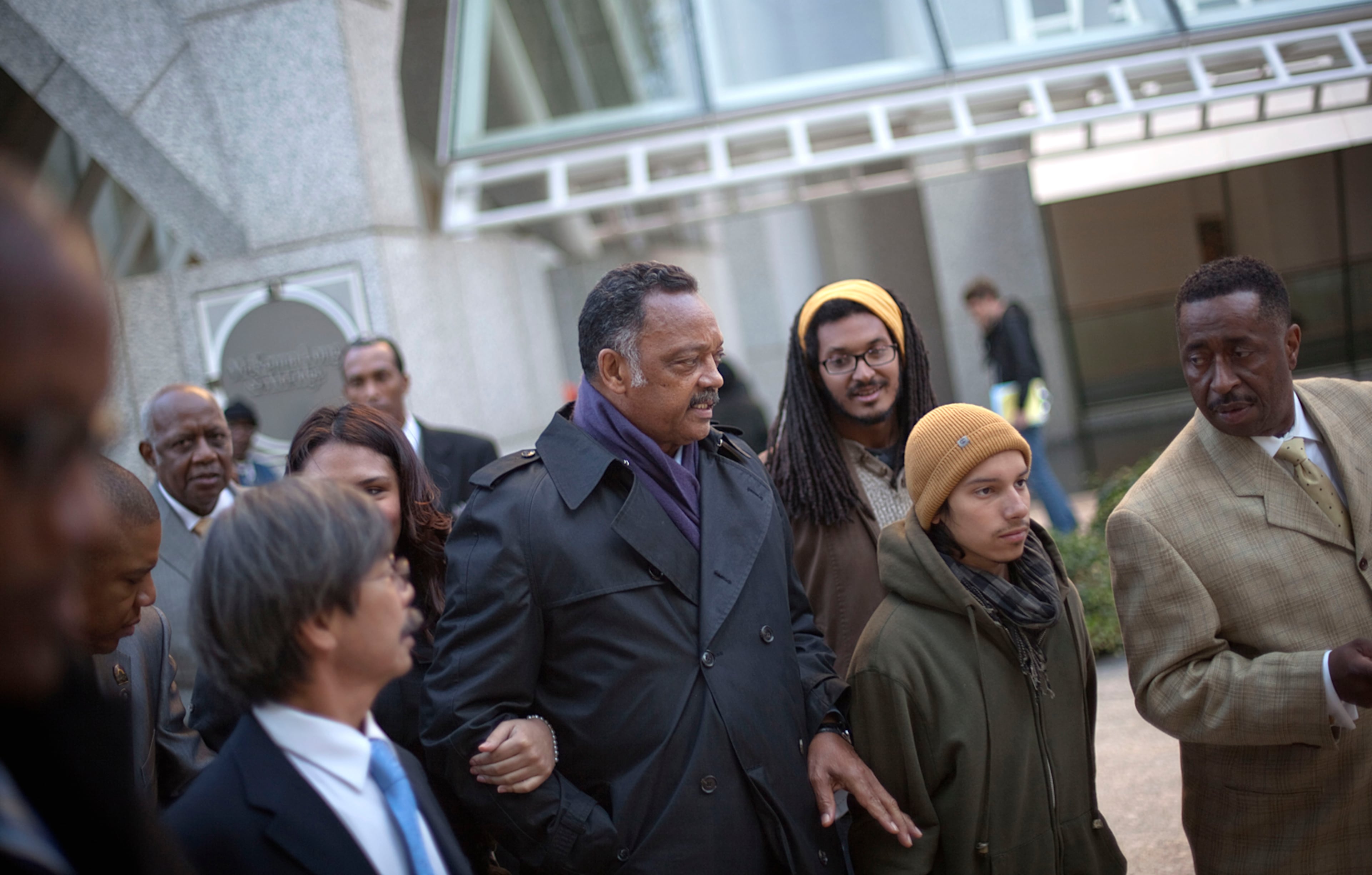 The Rev. Jesse Jackson, center, exits the SunTrust Bank headquarters after taking over the lobby with Occupy Atlanta protestors Friday, Nov. 4, 2011 in Atlanta. Jackson joined about 30 protesters who entered the lobby near closing time on Friday to protest economic conditions and foreclosure rates across the country.