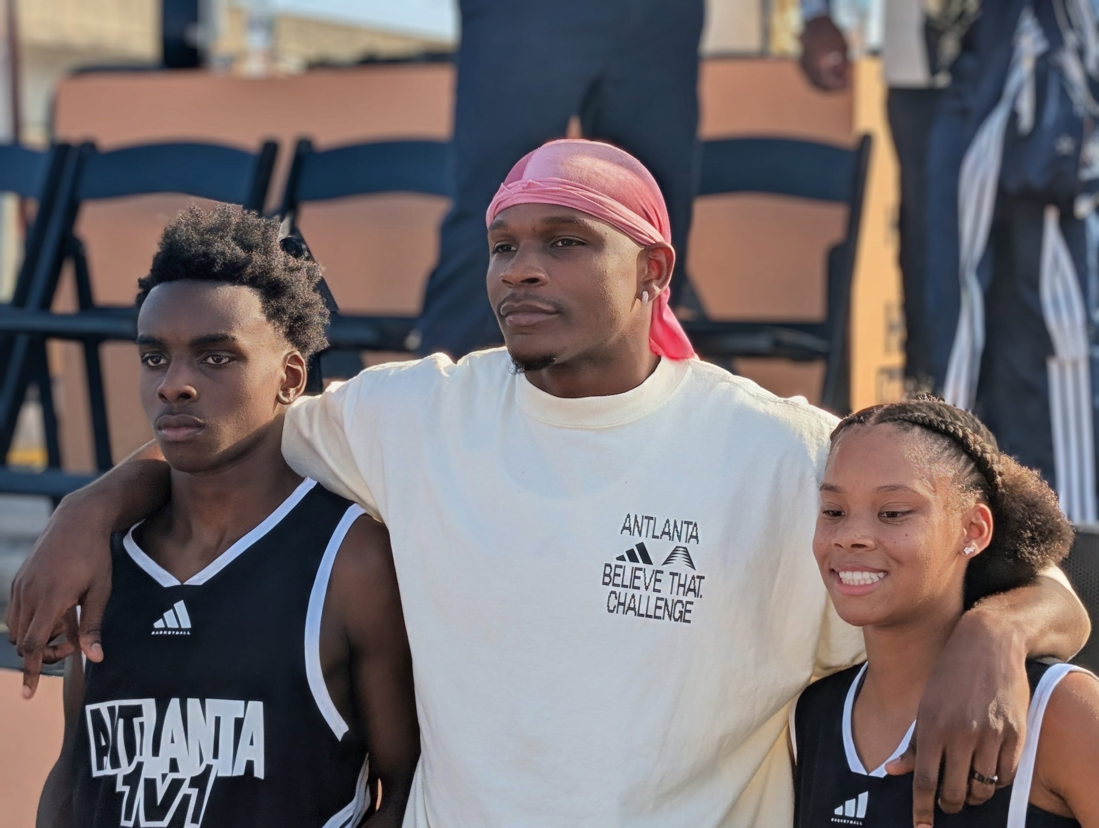 Anthony Edwards takes photos with two teenage athletes who participated in his basketball tournament. (Courtesy of A.R. Shaw)