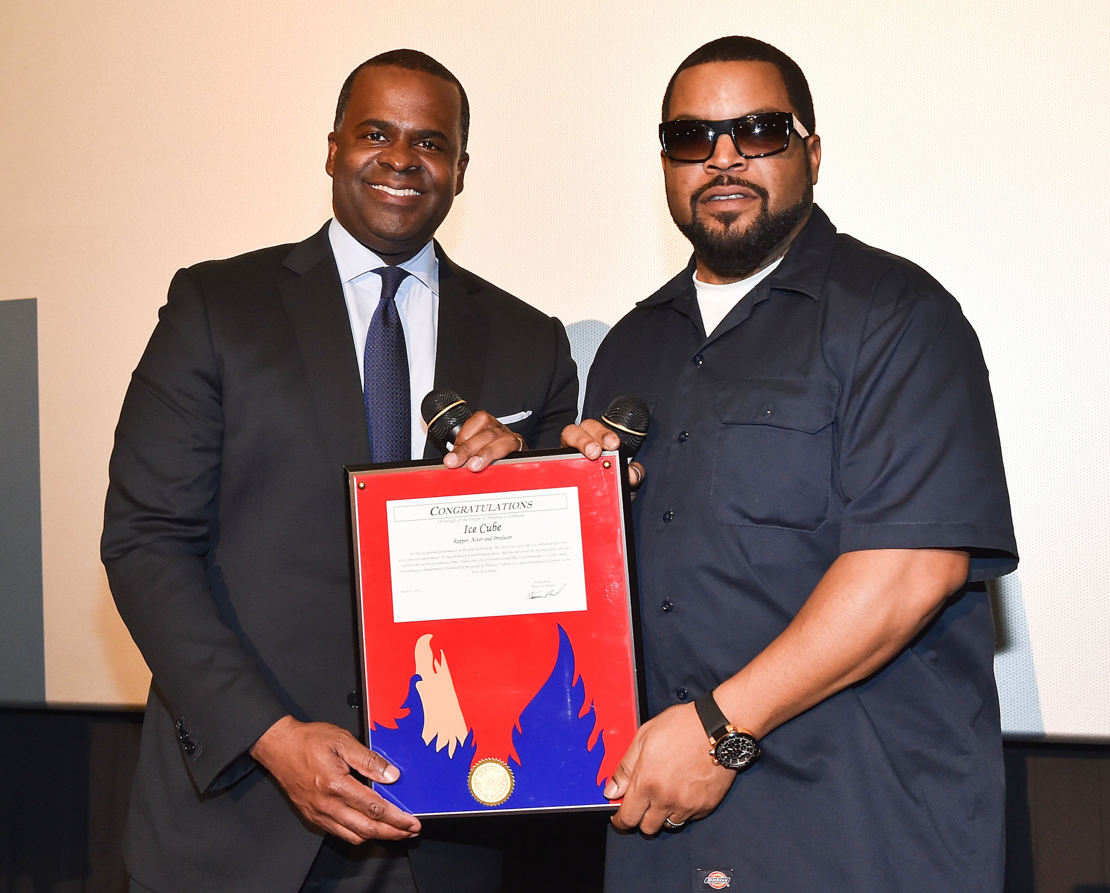 Ice Cube (right) — pictured accepting the City of Atlanta Phoenix Award from Atlanta Mayor Kasim Reed at an advance screening of Ice Cube's "Barbershop: The Next Cut" in 2016 in Atlanta — has filmed several other movies in Atlanta, including “Trespass” and “Ride Along." (Paras Griffin/Getty Images for Warner Bros 2016)