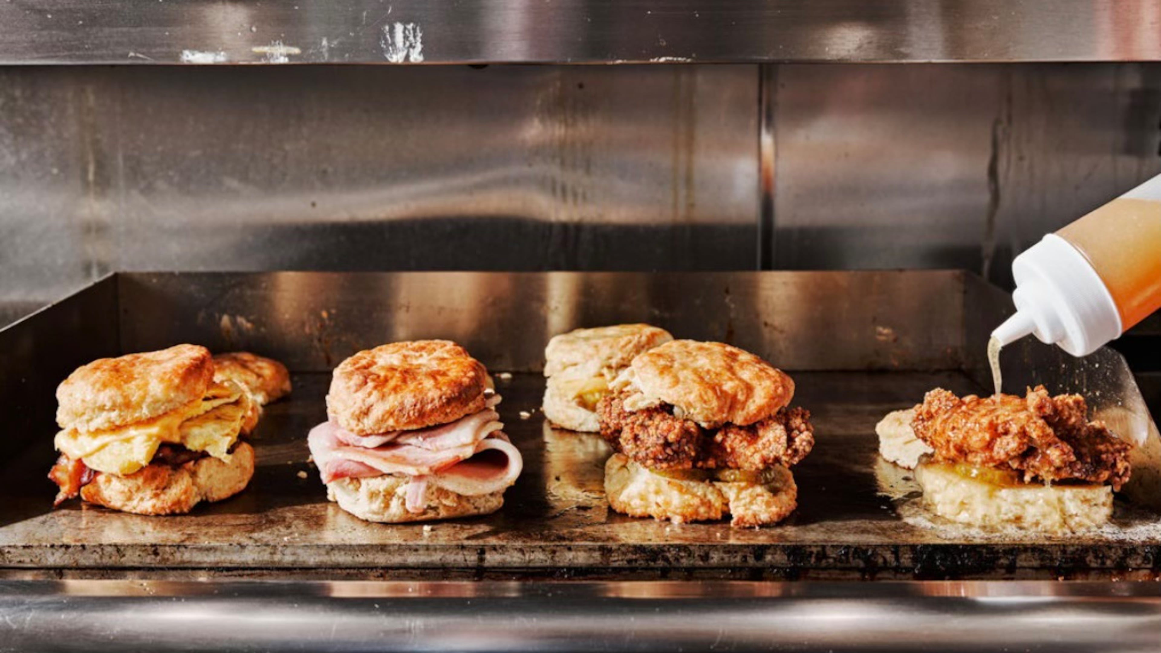 A variety of biscuits offered on Bomb Biscuit Co.'s menu are prepared on a griddle. (Courtesy of Andrew Thomas Lee)