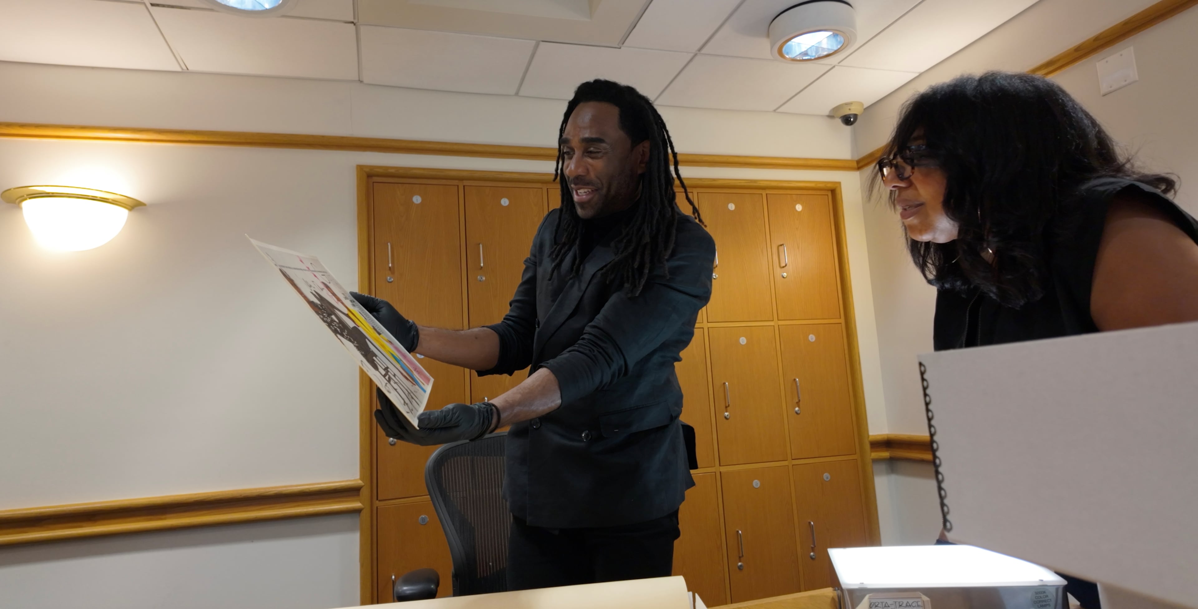 Executive producers Ray Cornelius (left) and Jessica L. Manning discover a treasure of archive photos at Schomburg Center for Research in Black Culture. Located in Harlem, the New York Library facility was gifted Kelly’s fashion photos, letters and videos by Bjorn Amelan, Kelly’s former business and life partner. (Courtesy of "Love, Patrick")