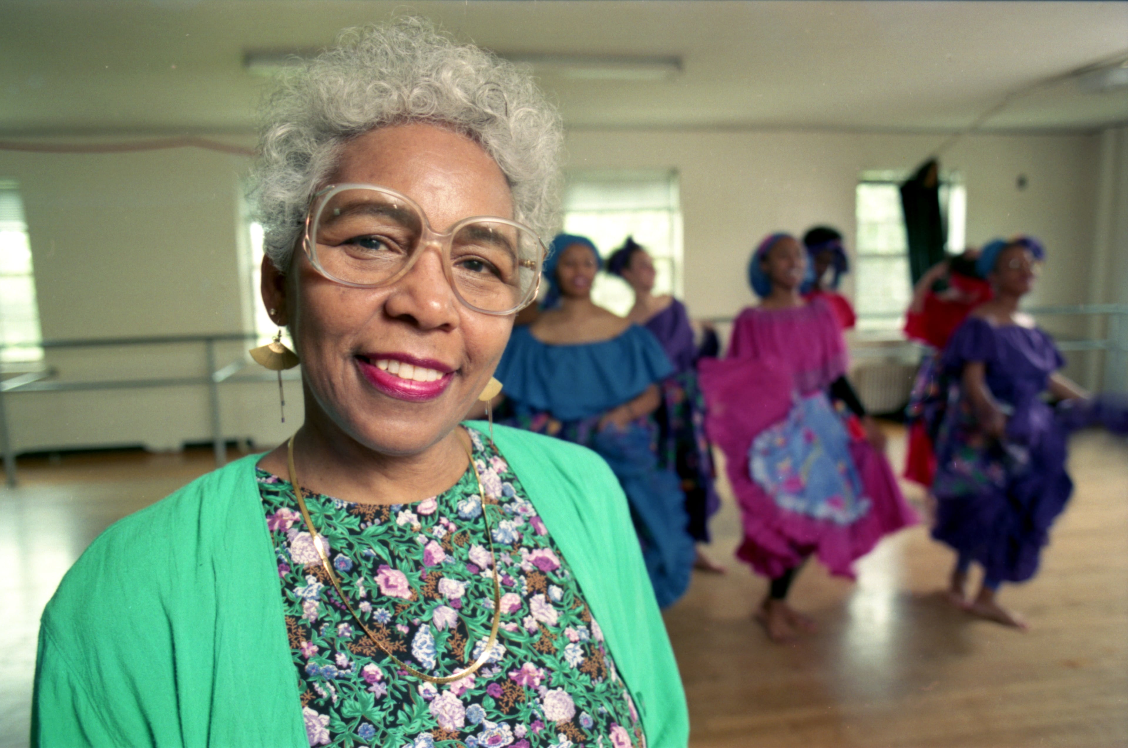 Mozel Spriggs, is seen in April 1991, two months before retiring from the Spelman College dance program after 27 years. Behind her, Spelman students dance. (Louie Favorite/AJC 1991)
