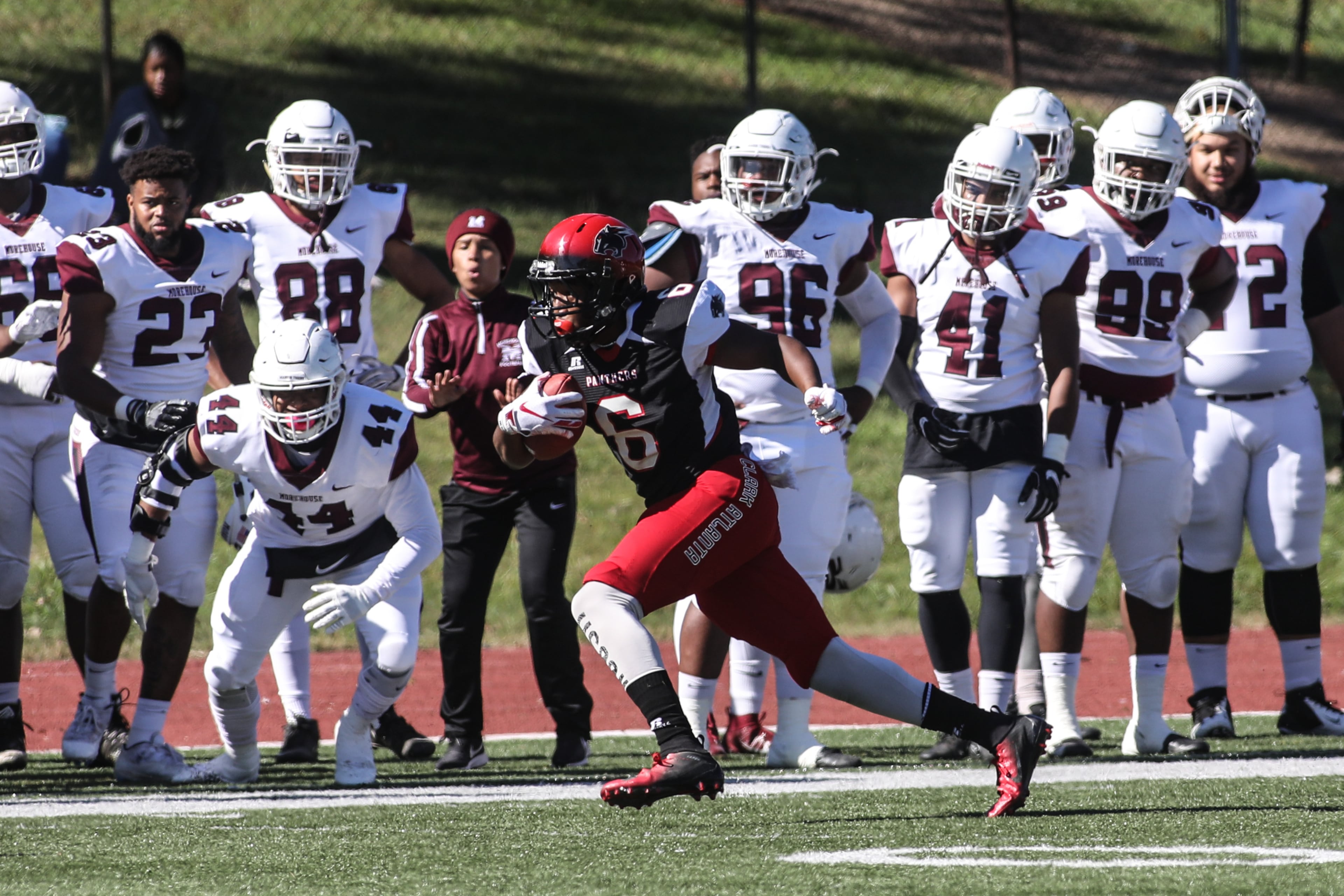 Morehouse players watch from the sideline as Clark Atlanta Panthers wide receiver Felix Jones (1) runs the ball during a college football game, Saturday, Nov. 3, 2018, in Atlanta. (Branden Camp/Special)