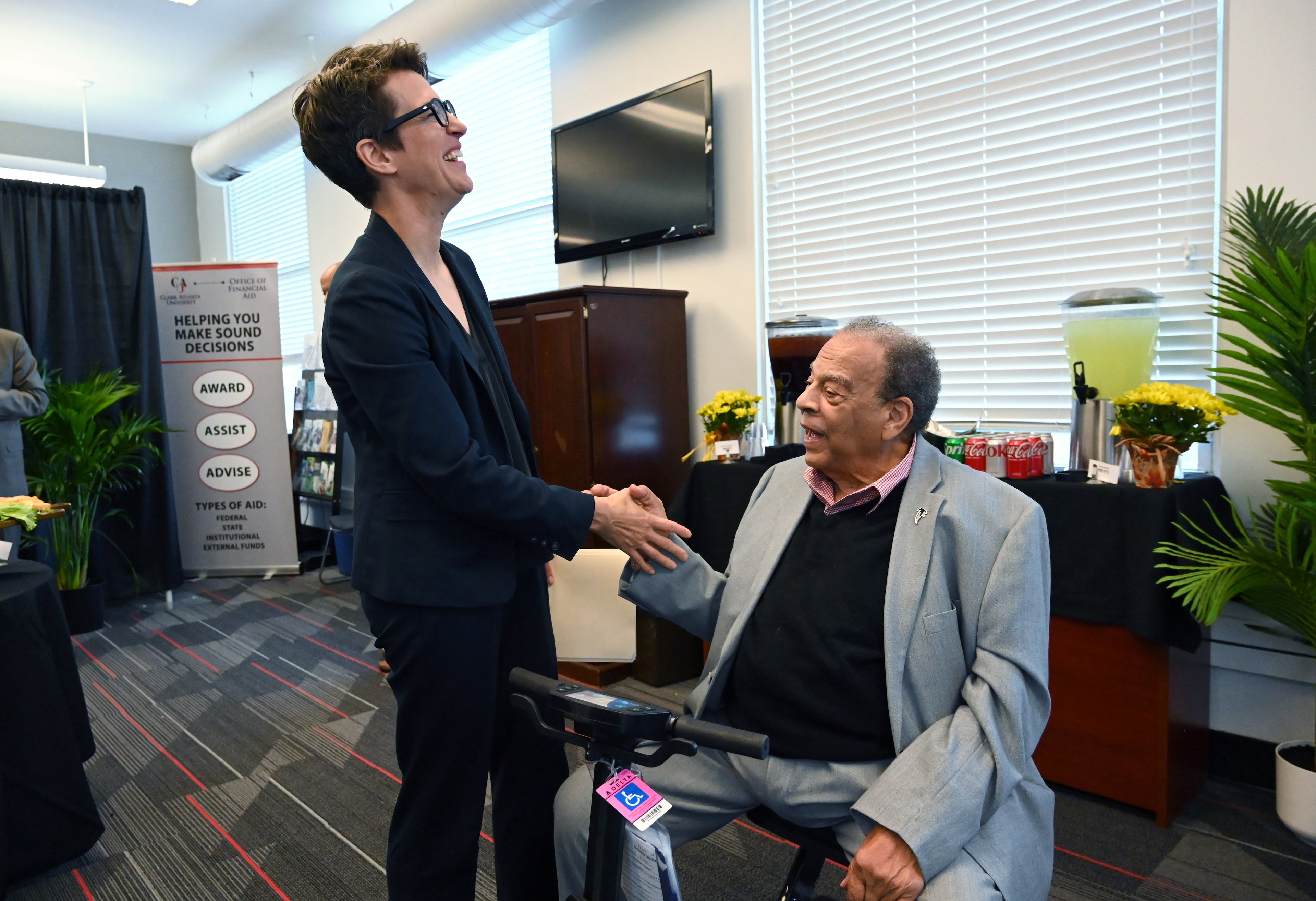 Executive producer Rachel Maddow is greeted by Ambassador Andrew Young before a special panel conversation ahead of the world premiere of the MSNBC documentary “Andrew Young: The Dirty Work,” at Clark Atlanta University on Tuesday, Oct. 14, 2025. The conversation was led by the Rev. Al Sharpton. (Hyosub Shin/AJC)