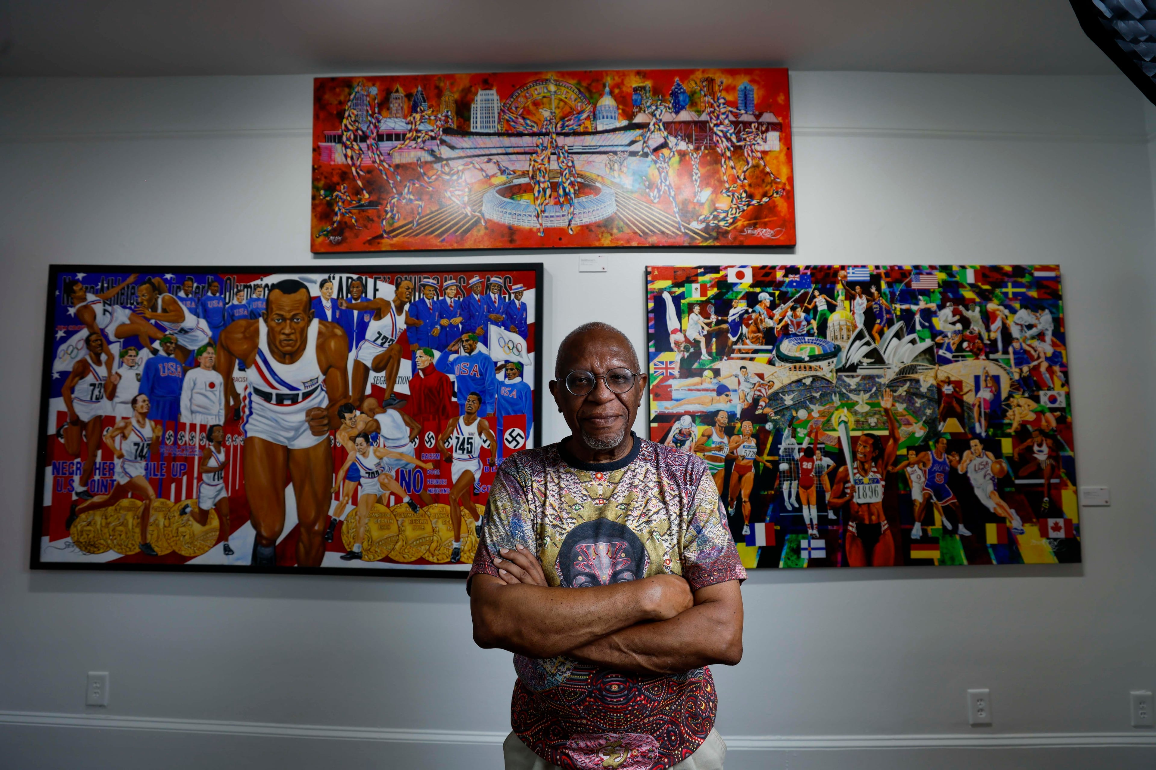 Visual artist Steve Allen poses on the second floor of one of his exhibits at the Hammonds House Museum on Thursday, August 20, 2026. Allen’s exhibit comprises two parts. Downstairs is “Infinite Inheritance” and upstairs is “O Jogo Bonito (The Beautiful Game).” The downstairs section explores Black ancestry, while the upstairs exhibition features works inspired by the Olympic Games. (Miguel Martinez/AJC)