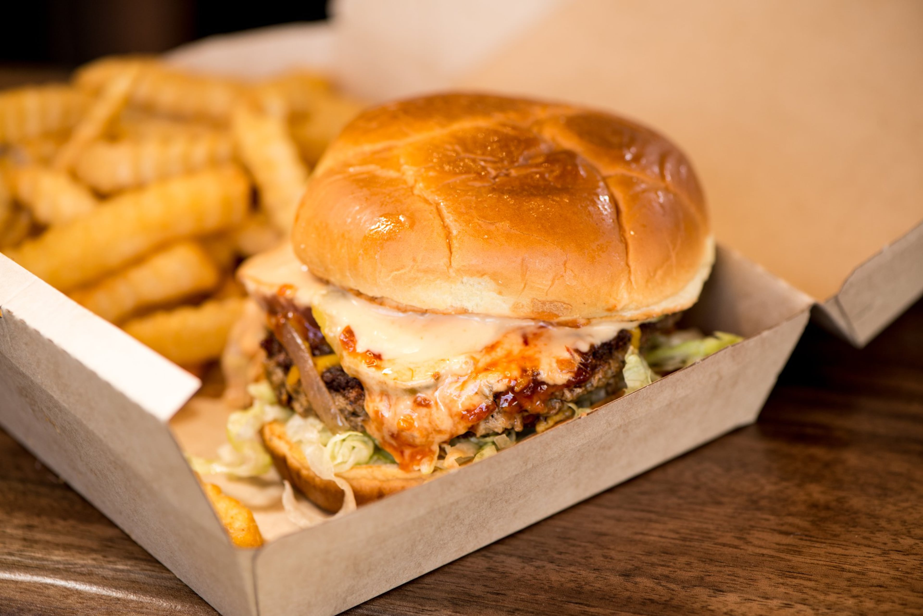 Slutty Vegan’s Fussy Hussy is a plant-based patty with vegan American cheese, shredded lettuce, onion, pickle and vegan mayo on a vegan Hawaiian bun. (Courtesy of Mia Yakel)