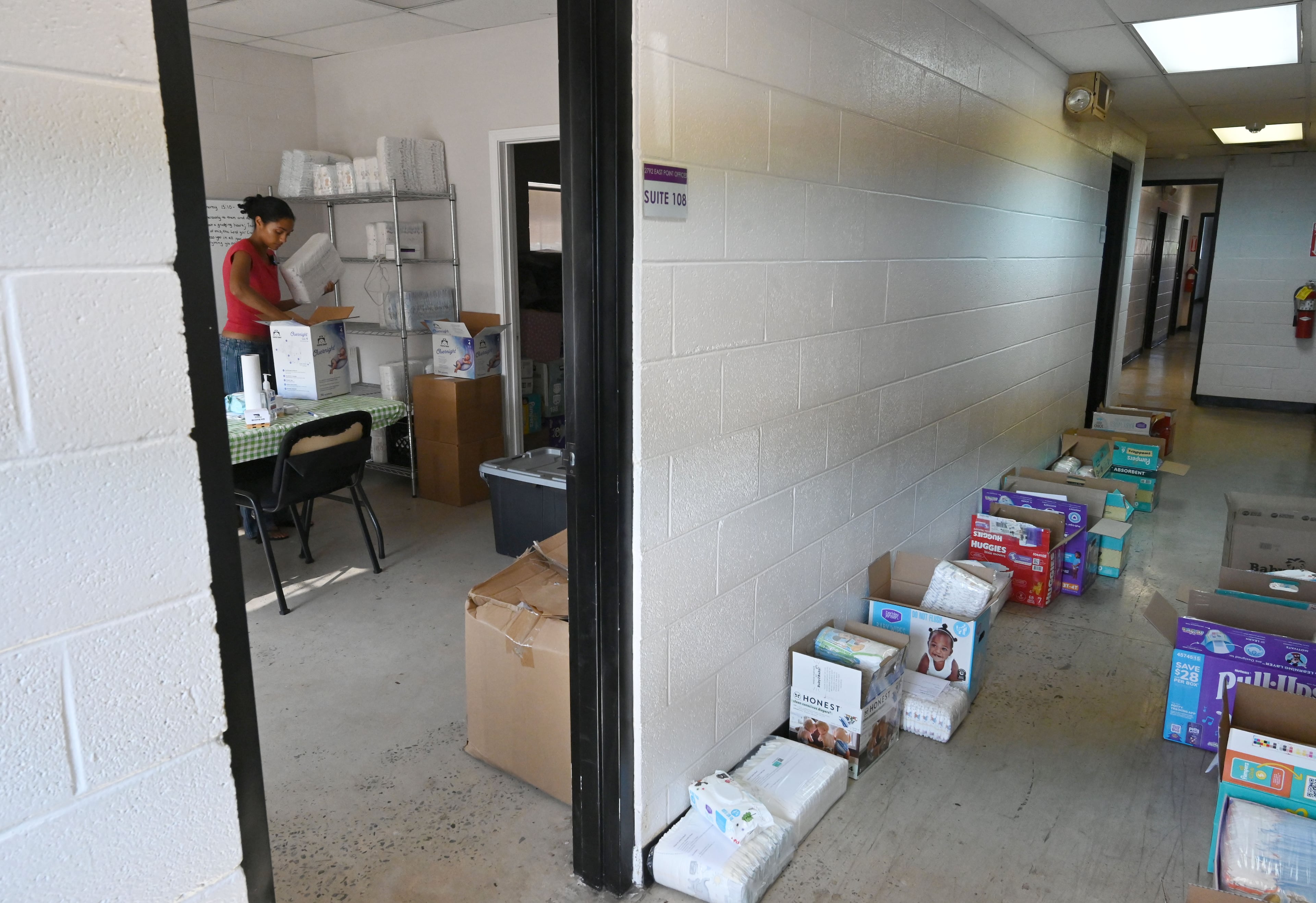 Jaycina Almond prepares baby supplies before families and volunteers arrive for pickup at the Tender Foundation's Diaper Bank on Saturday, July 11, 2026, in East Point. (Hyosub Shin/AJC)