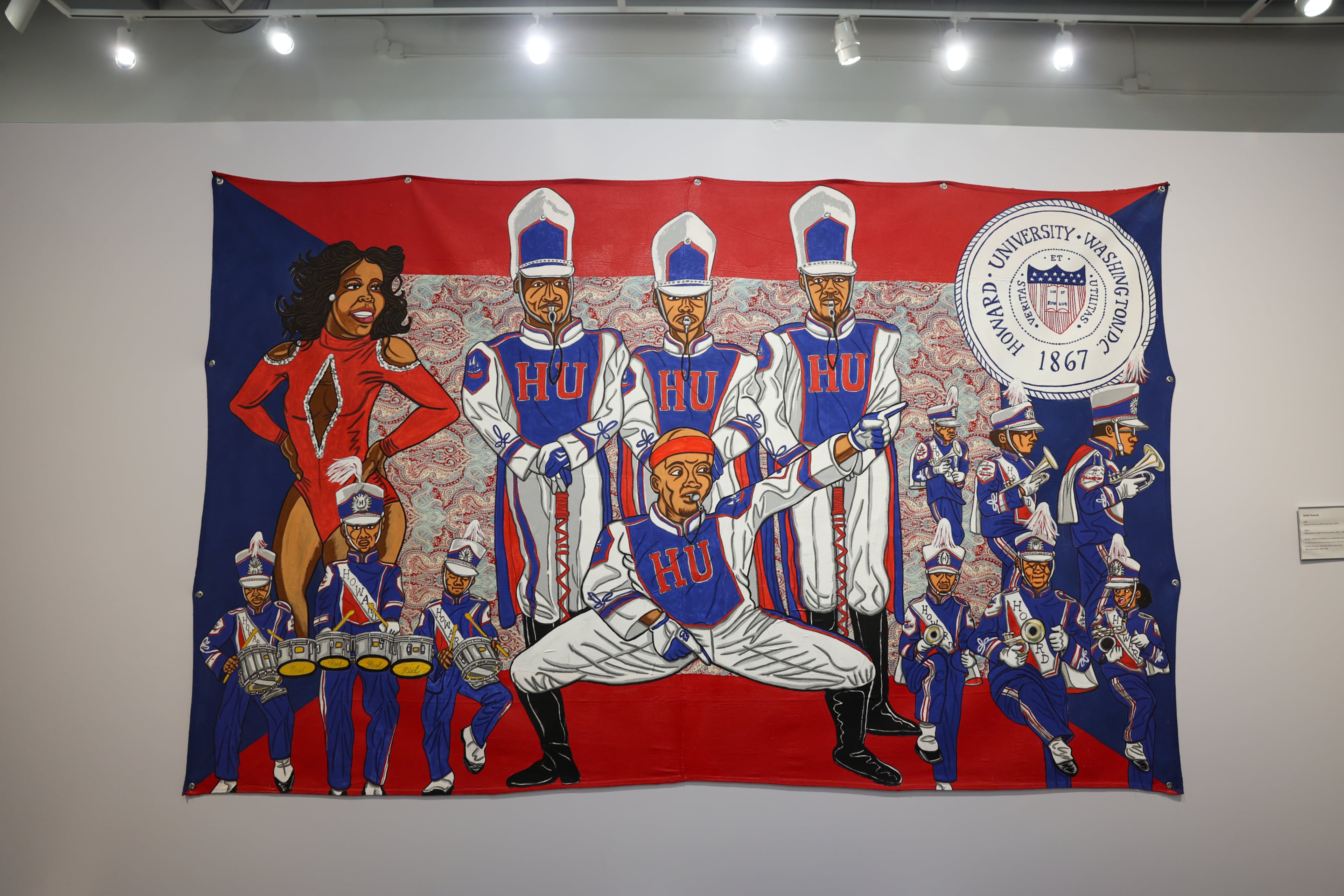 A piece from artist Keith Duncan’s exhibit “Battle of the Bands,” inspired by HBCU band culture, is on display at the College Football Hall of Fame in Atlanta on Sept. 11, 2026. Duncan utilizes bright colors to convey the competition and pageantry between the bands. (Arvin Temkar/AJC)