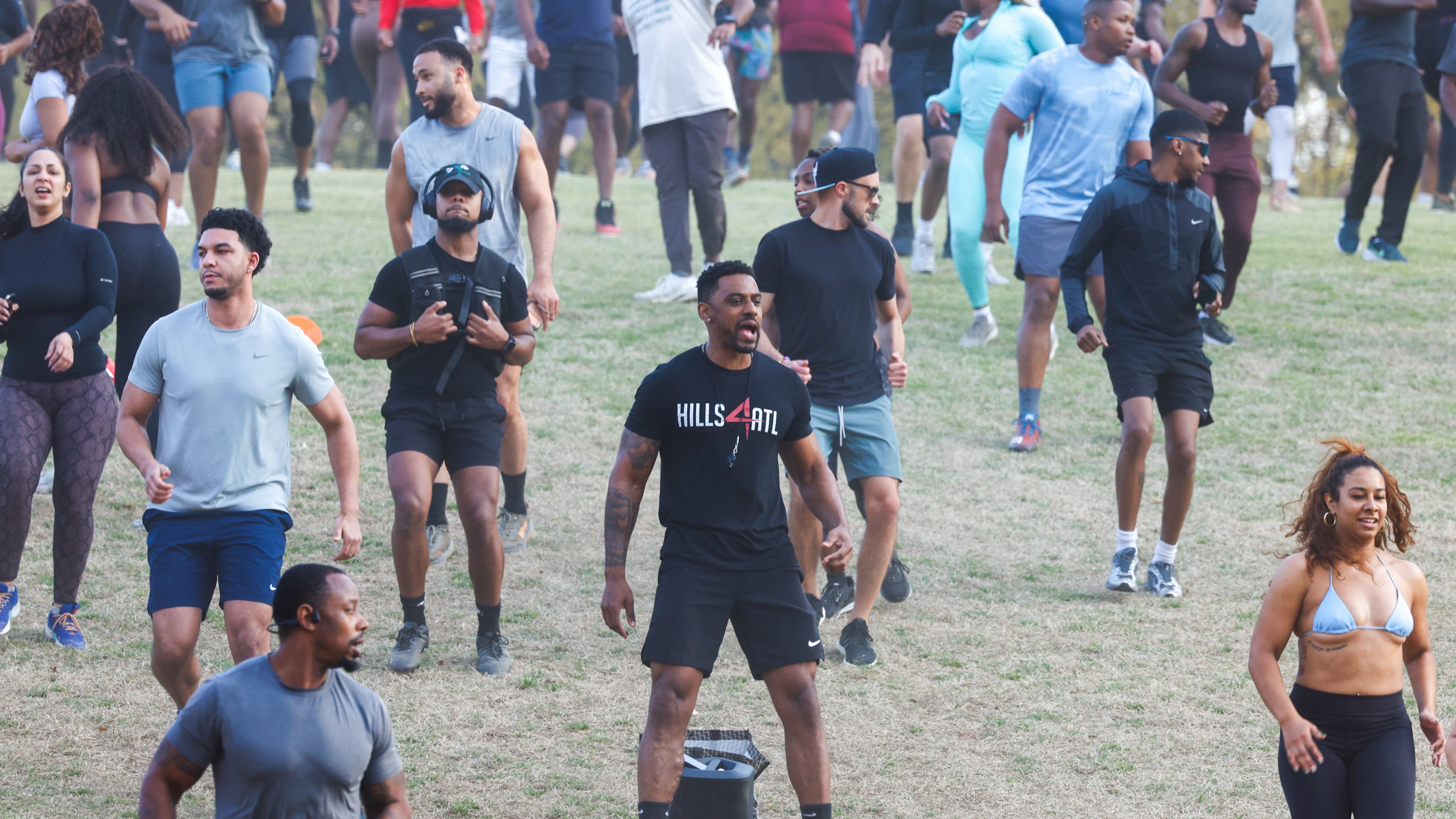 Alvin Bailey (center) leads the Hills4ATL fitness group exercise event at Piedmont Park in Atlanta on March 25, 2026. (Arvin Temkar/AJC)