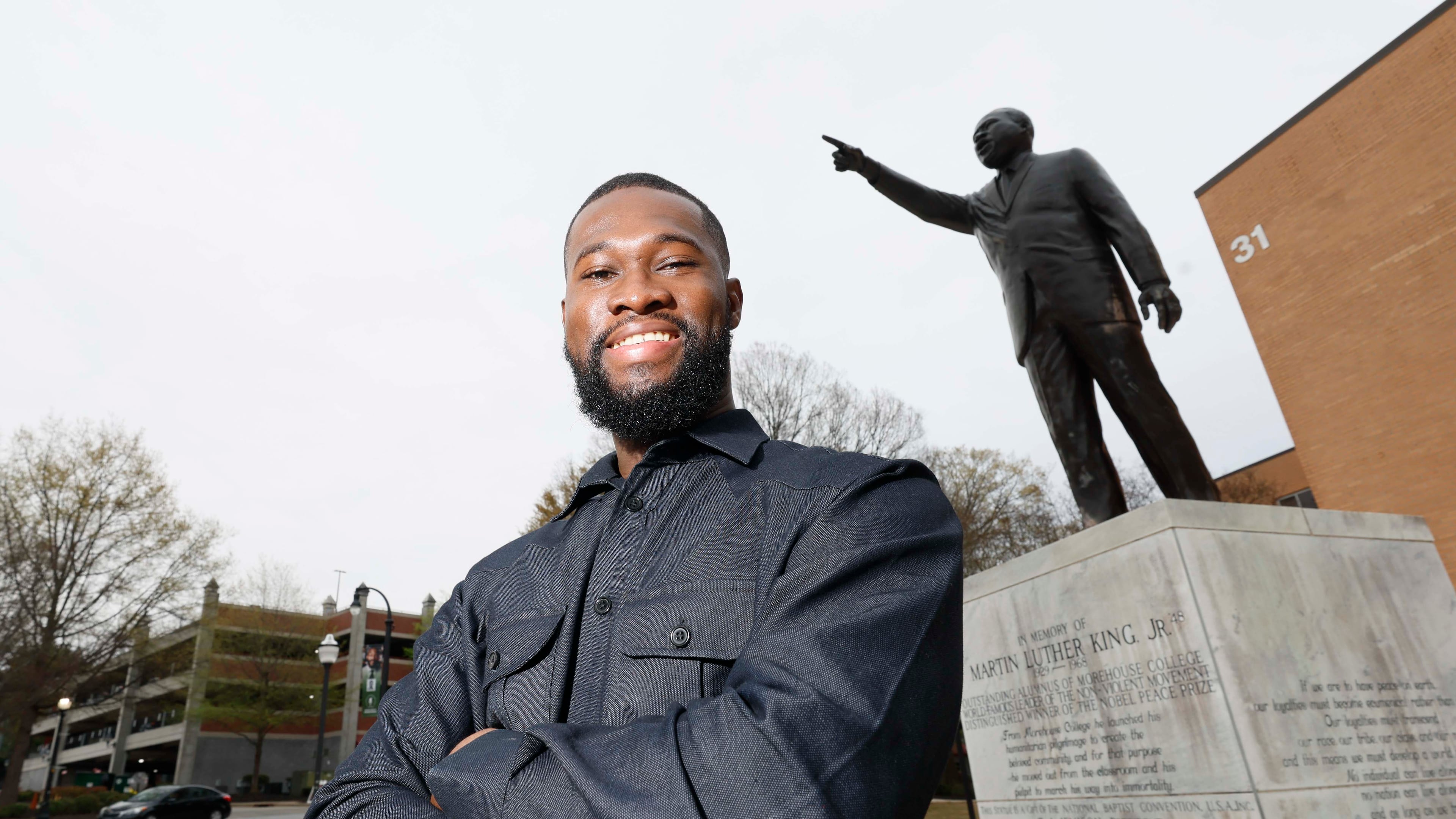 Rhodes Scholar Aniaba Jean-Baptiste N’Guessan poses next to the Martin Luther King Jr. statue at the MLK International Chapel at Morehouse College on Wednesday, March 25, 2026. N’Guessan, the sixth Morehouse student to earn the Rhodes scholarship, is a senior triple majoring in economics, mathematics and computer science from Abidjan, Côte d’Ivoire. (Miguel Martinez/AJC)