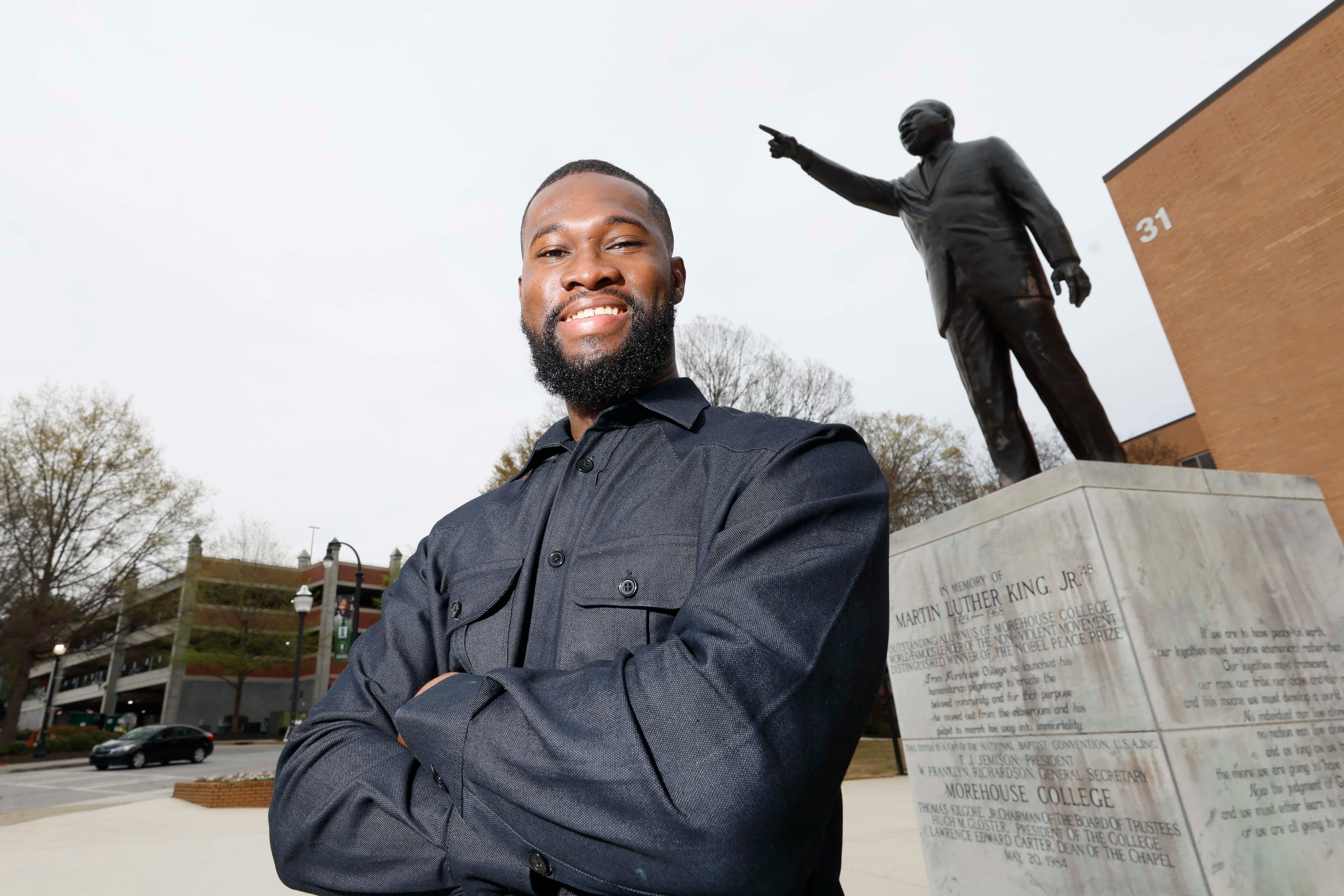 Rhodes Scholar Aniaba Jean-Baptiste N’Guessan poses next to the Martin Luther King Jr. statue at the MLK International Chapel at Morehouse College on Wednesday, March 25, 2026. N’Guessan, the sixth Morehouse student to earn the Rhodes scholarship, is a senior triple majoring in economics, mathematics and computer science from Abidjan, Côte d’Ivoire. (Miguel Martinez/AJC)