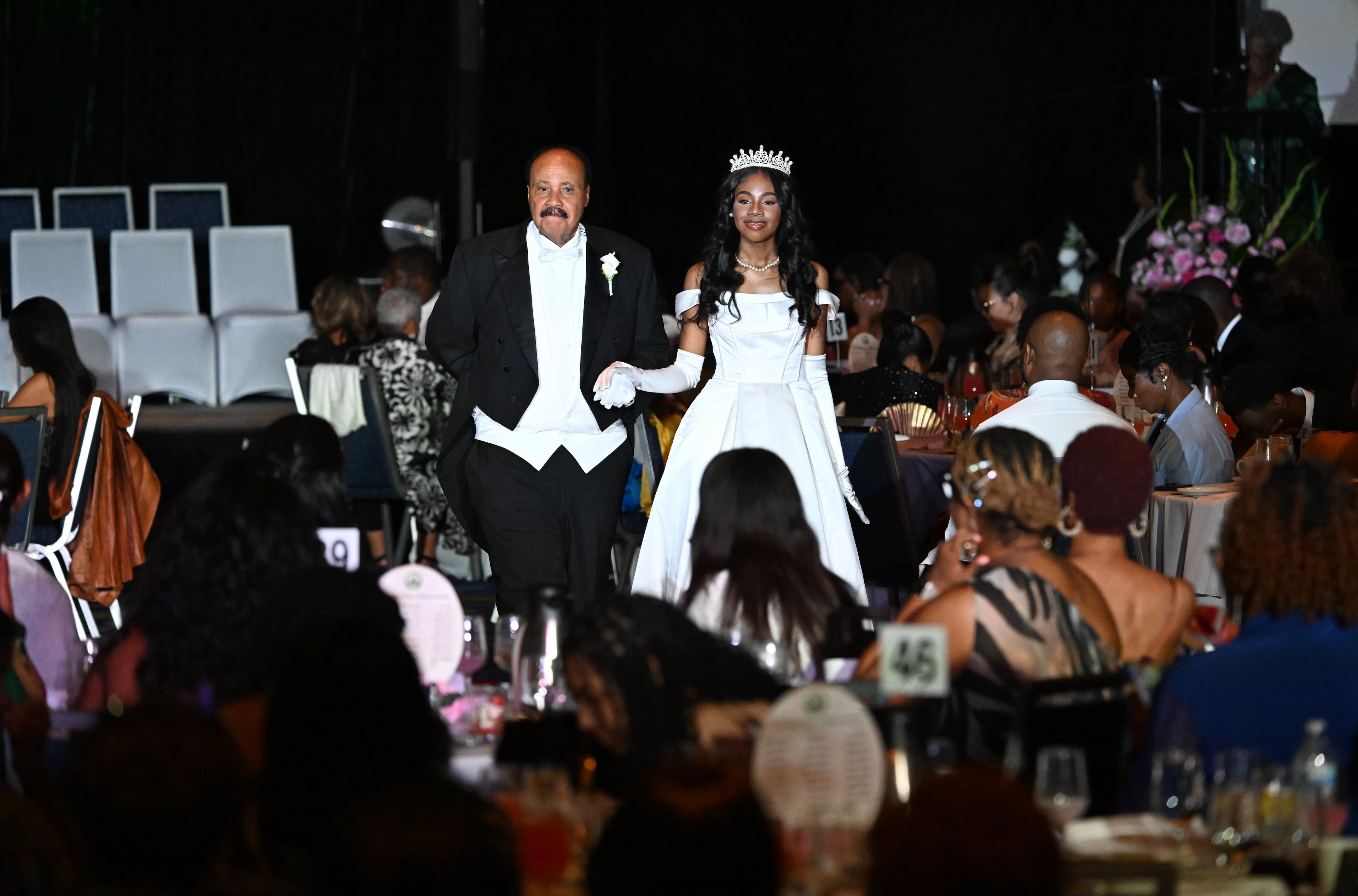 Debutante Yolanda Renee King is escorted by her father, Martin Luther King III, during the 2026 Pink Cultured Pearls Cotillion sponsored by the Ivy Community Foundation at the Georgia International Convention Center on March 29, 2026 in Atlanta. (Hyosub Shin/AJC)