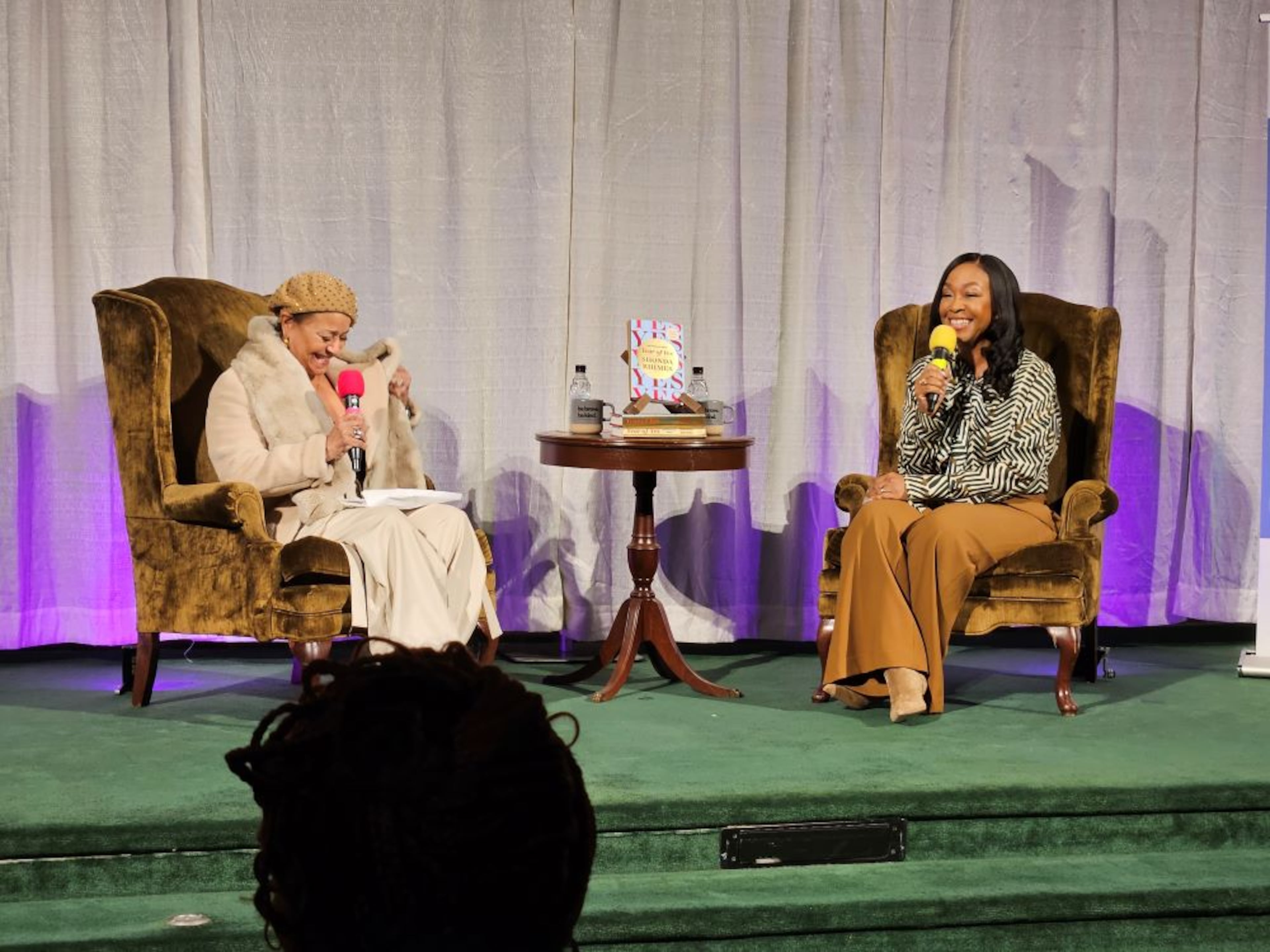 Choreographer and director Debbie Allen (l.) tells jokes with series creator and executive producer Shonda Rhimes (r.) at 'Year of Yes' 10th anniversary book tour at First Baptist Church of Decatur on Thursday, Oct. 23, 2025. (Christopher A. Daniel/AJC)