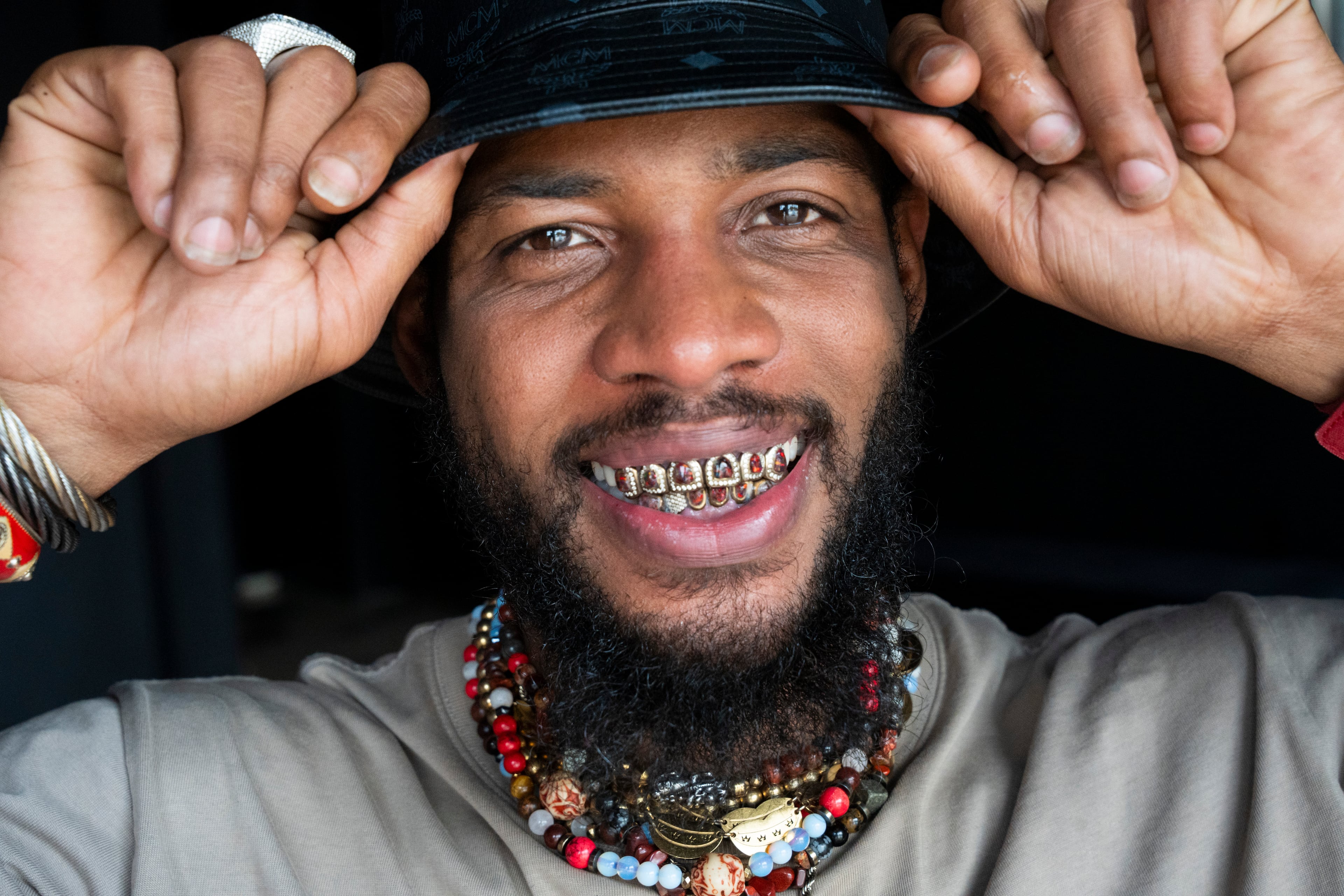 Jabril Trawick, known as Brill Lightyear and owner of Ndstry ATL creative studio, shows off his grills made by his cousin, Haz Musa, in Atlanta on Saturday, Sept. 6, 2025. (Olivia Bowdoin for the AJC)