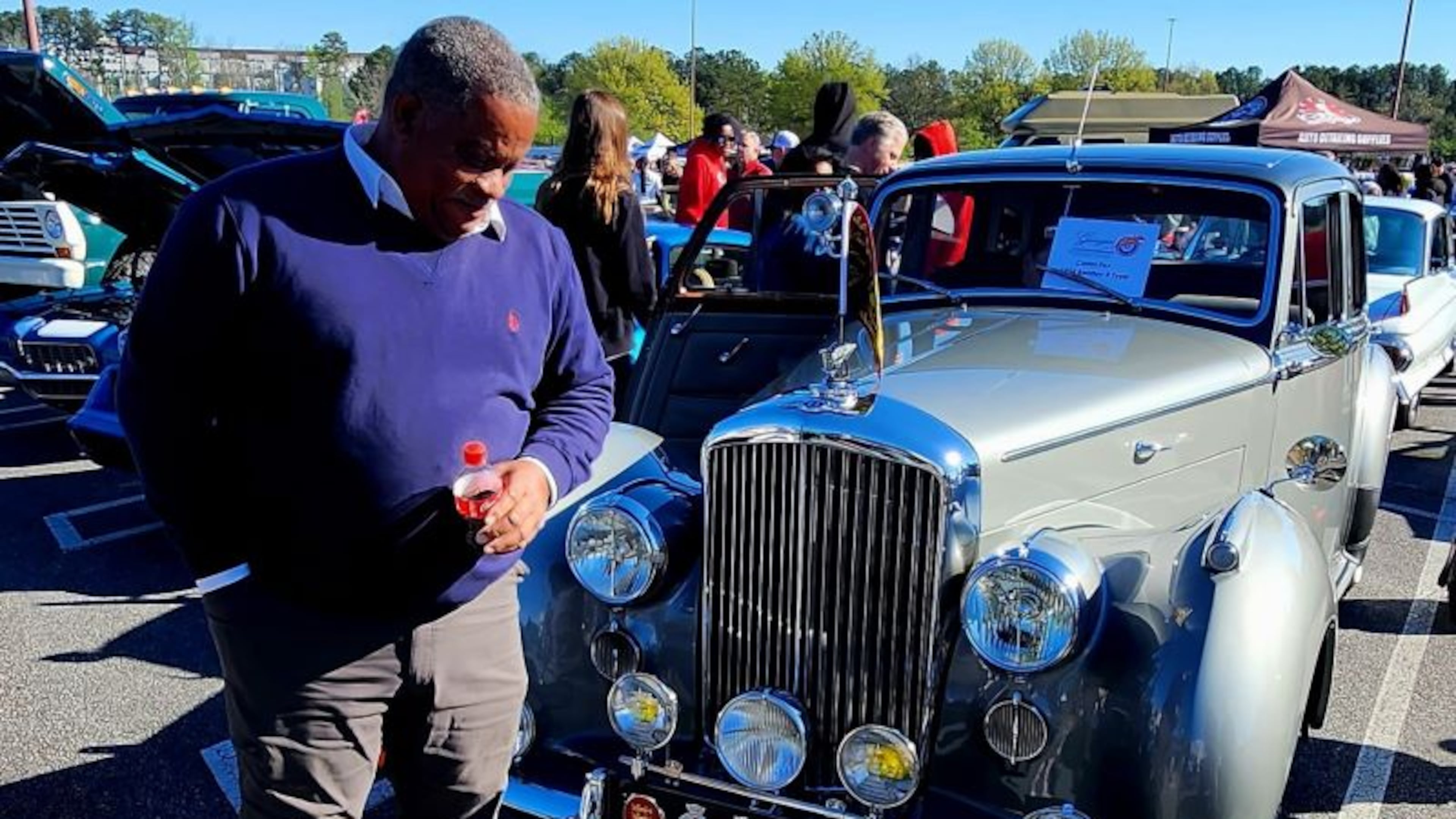 Atlanta Motoring Festival and Concours d'Elegance co-chairman Aaron Spaulding poses by a 1954 Bentley R Type.