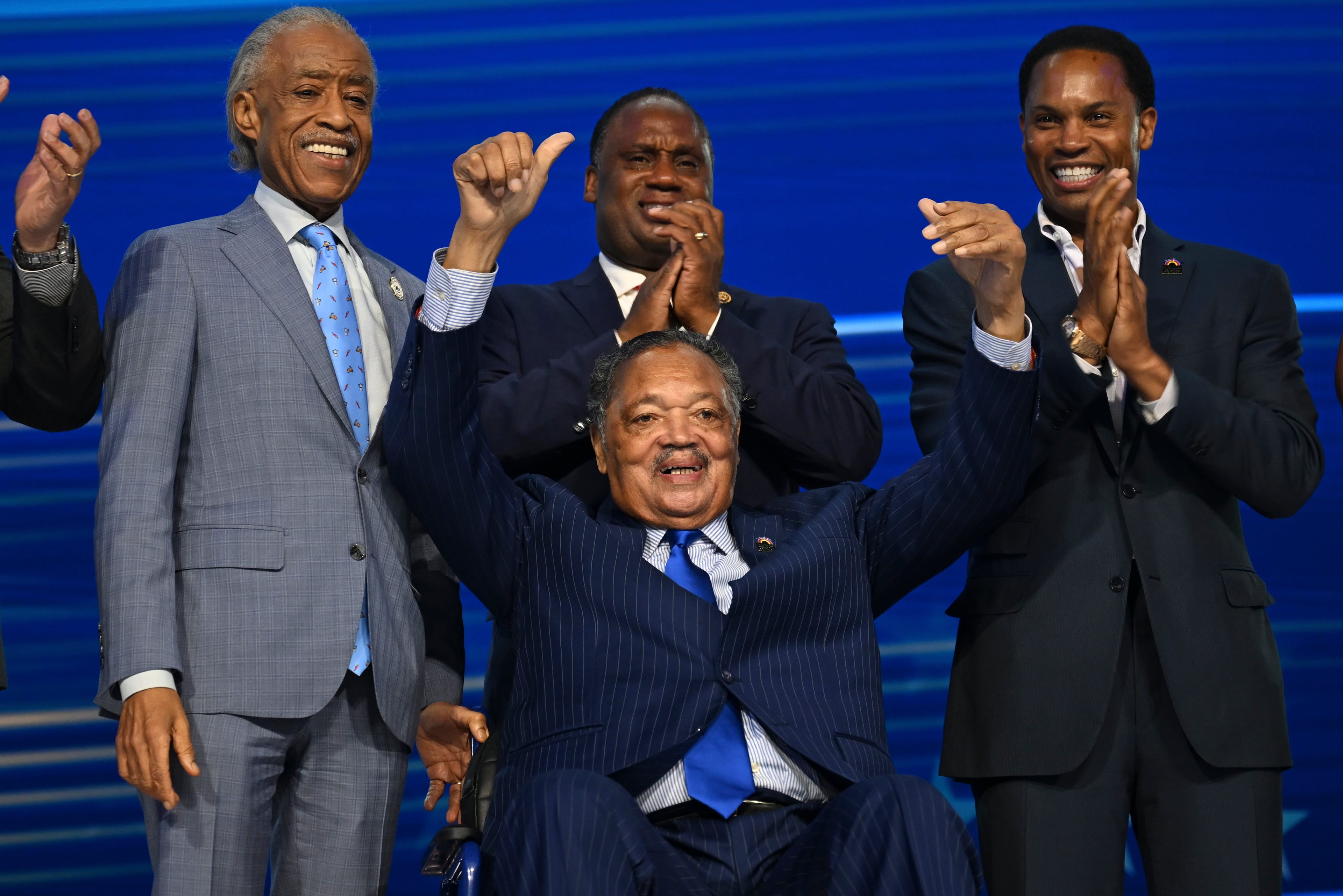 The Rev. Jesse Jackson (center) and the Rev. Al Sharpton, (left) make an appearance on stage on the first night of the Democratic National Convention at the United Center in Chicago on Monday, Aug. 19, 2024. (Kenny Holston/The New York Times)
