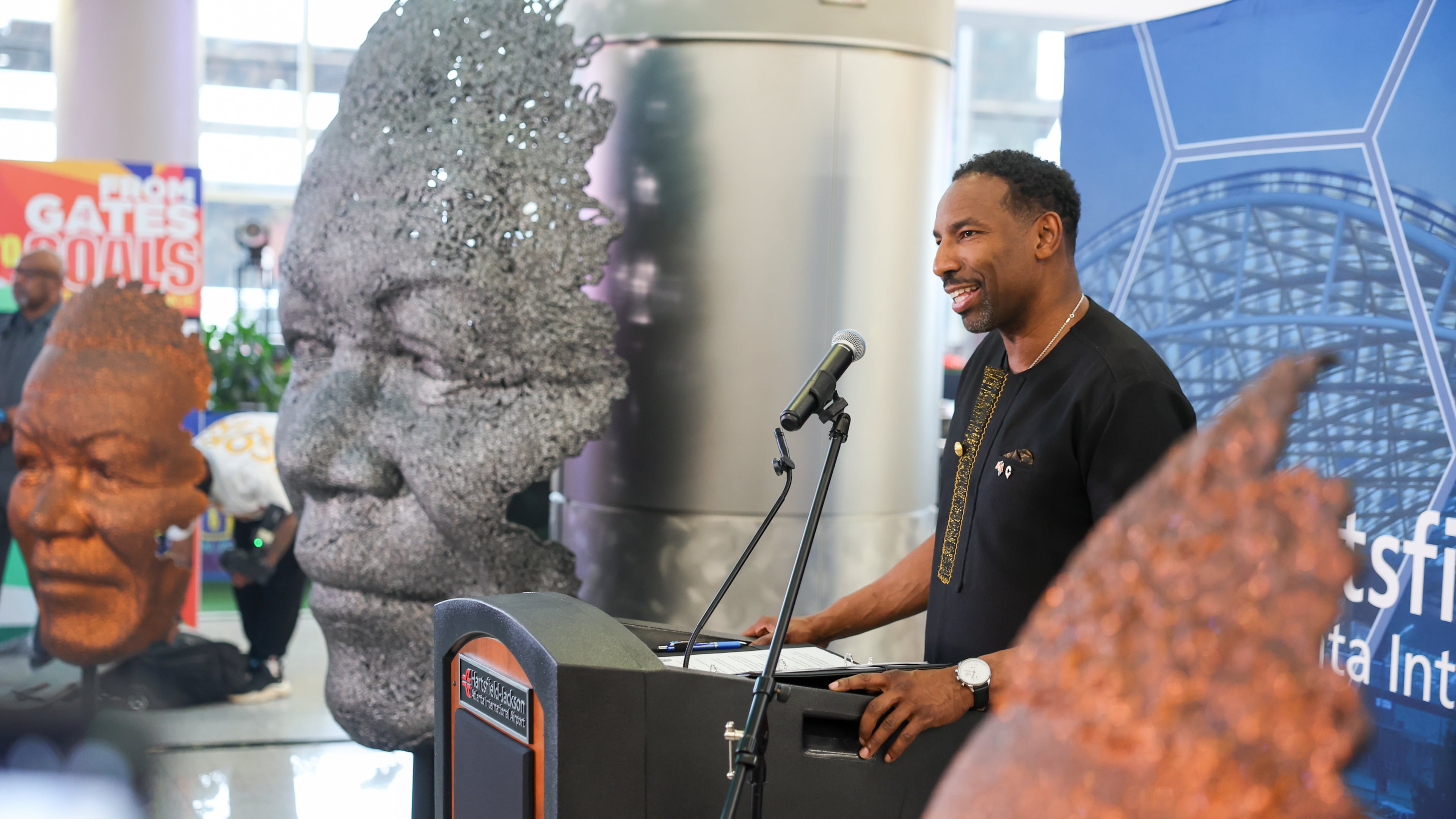 Atlanta Mayor Andre Dickens speaks at a ceremony unveiling a Nelson Mandela sculpture in the international terminal at Hartsfield-Jackson Atlanta International Airport on Wednesday, May 27, 2026. The sculpture was gifted to the city during Dickens’ visit to South Africa in 2024. (Arvin Temkar/AJC)