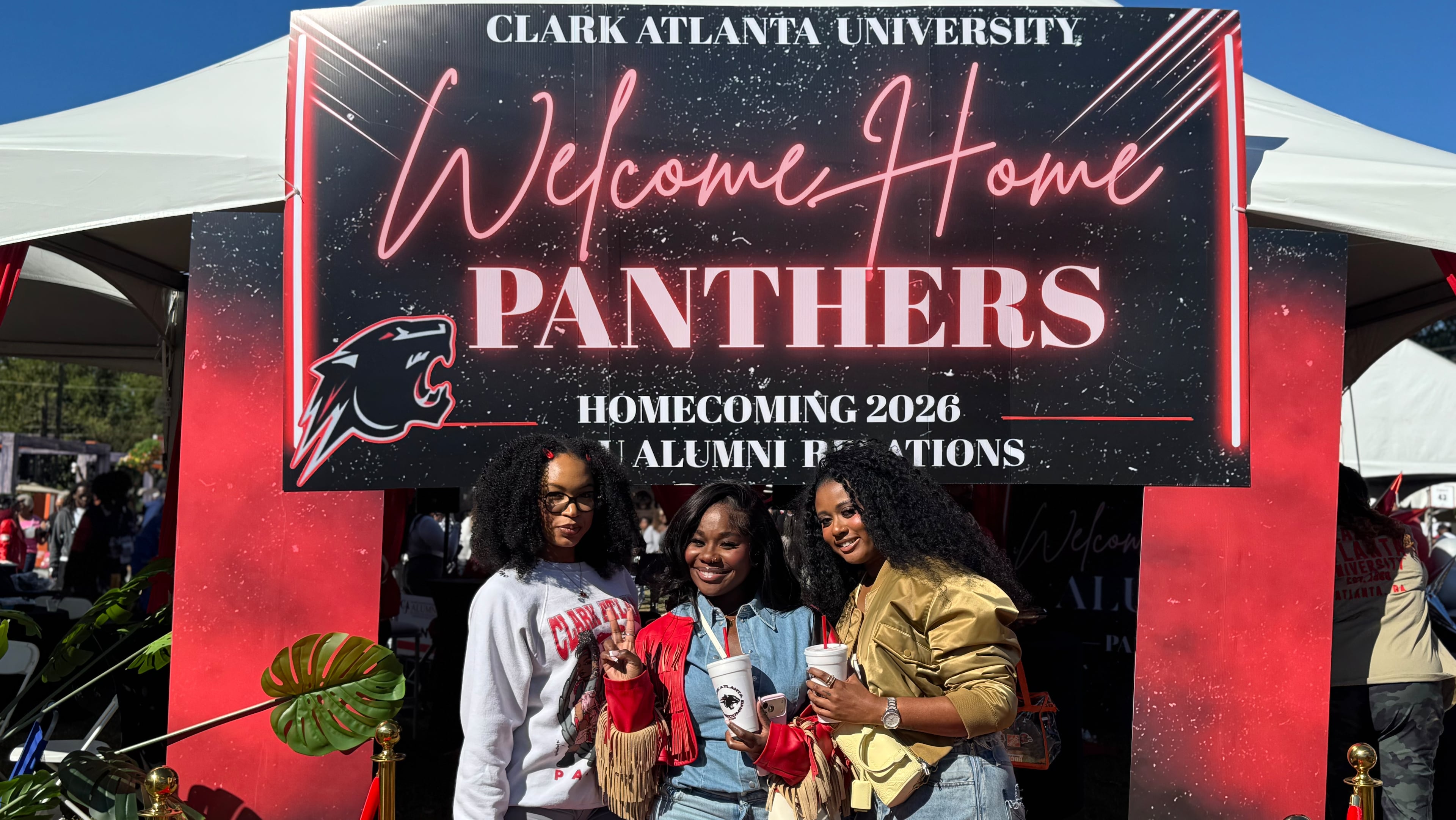 During Clark Atlanta University homecoming on Oct. 17, 2026, alumni (from L to R) Dazhane Johnson (Class of 2022), Bianca Janvier (Class of 2021) and Faith Hall (Class of 2021) attend tailgating at tents next to the CAU Panther Stadium. (Brooke Leigh Howard/AJC)