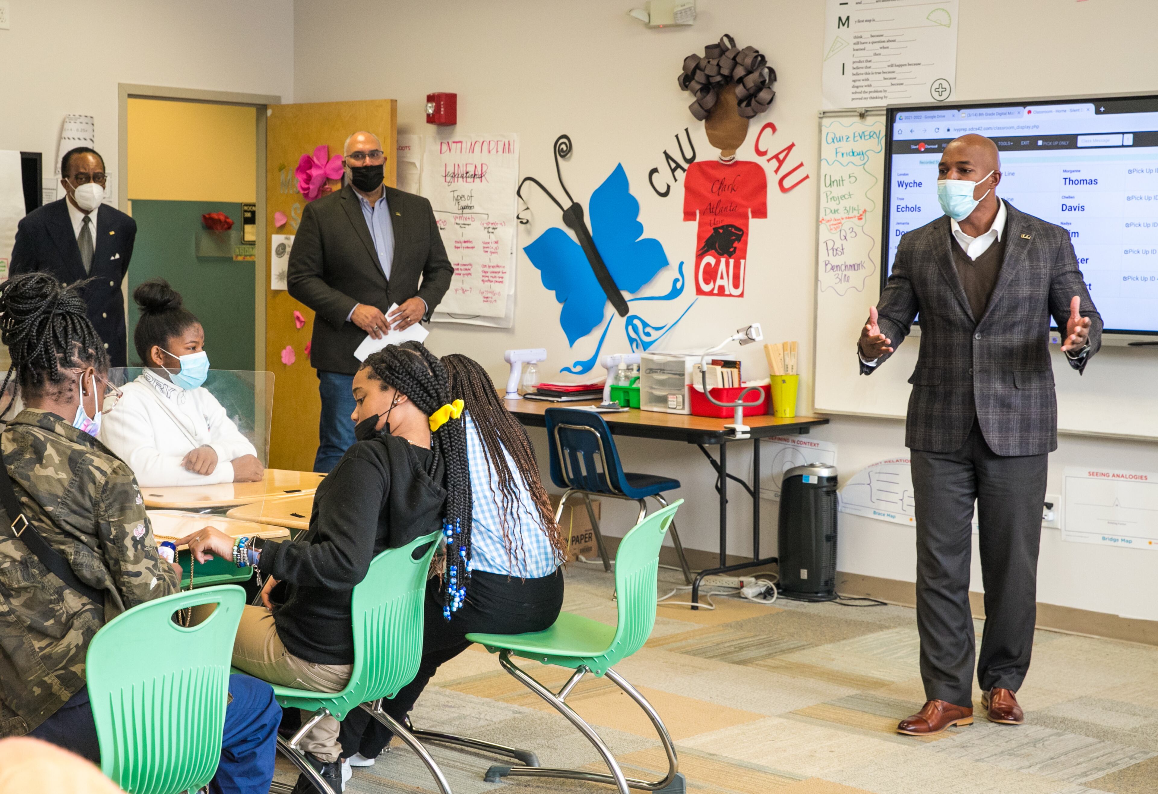 Members of 100 Black Men, including Joshua Byrd, leading the program, offer mentoring and an anti-gun violence program to students at Ivy Prep Academy on Wednesday, March 16, 2022. The program provides several weeks of after-school education in conflict resolution, personal choices, social media pitfalls and offers a student billboard competition while spreading awareness of gun violence. (Jenni Girtman for The Atlanta Journal Constitution)