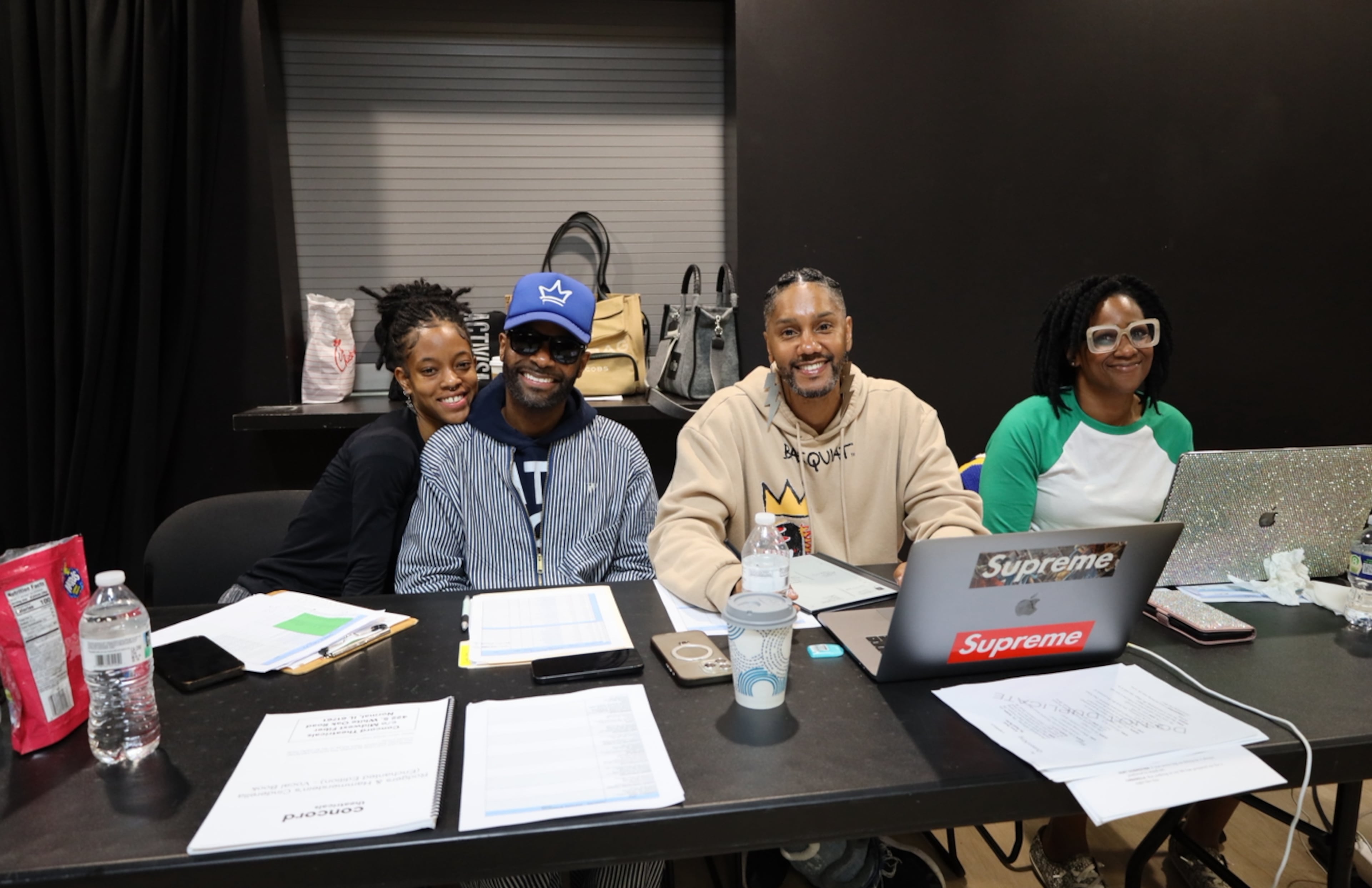Juel D. Lane (beige sweatshirt), director of "Cinderella," with members of his crew, Ina Kwayana, associate choreographer; Rahbi Hines, musical director; and Sharell D. Luckett, assistant director. (Courtesy of True Colors Theatre Company)