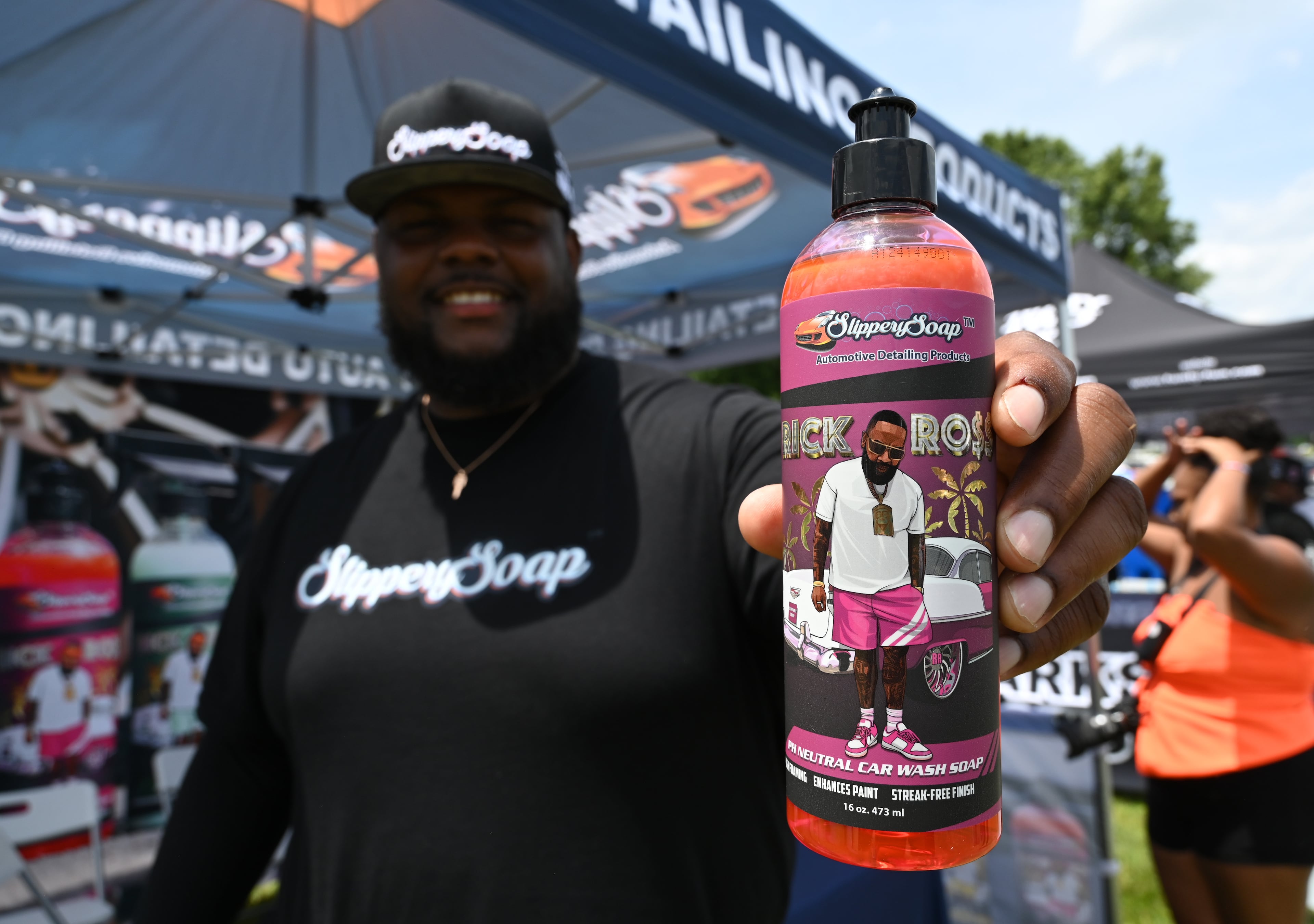 Jeremy Lewis, founder of Slippery Soap, shows his product during the fourth annual Rick Ross Car Show on Saturday in Fayetteville. (Hyosub Shin/AJC)