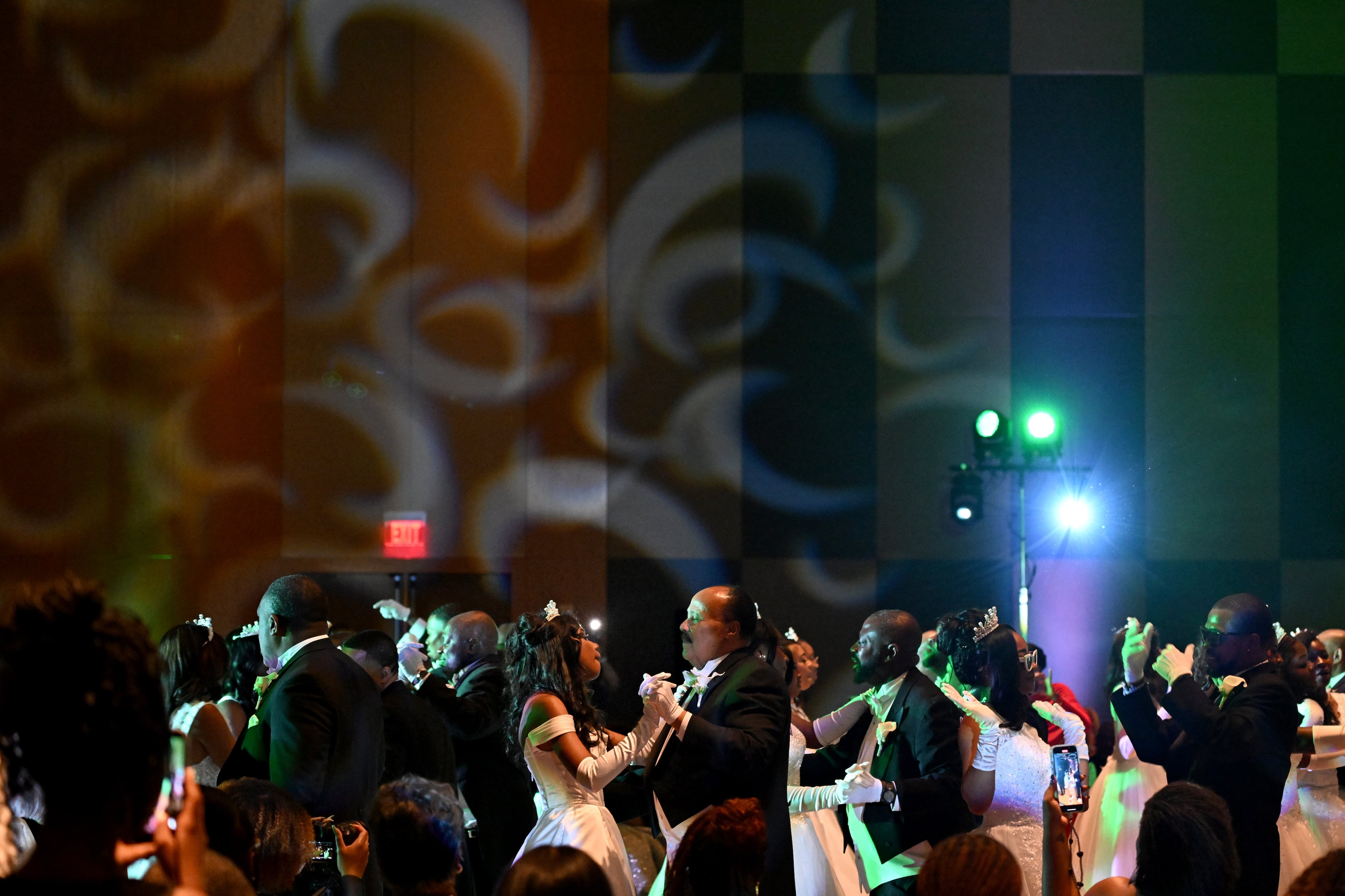 Yolanda Renee King (center) dances with her father, Martin Luther King III, during the 2026 Pink Cultured Pearls Cotillion. (Hyosub Shin/AJC)