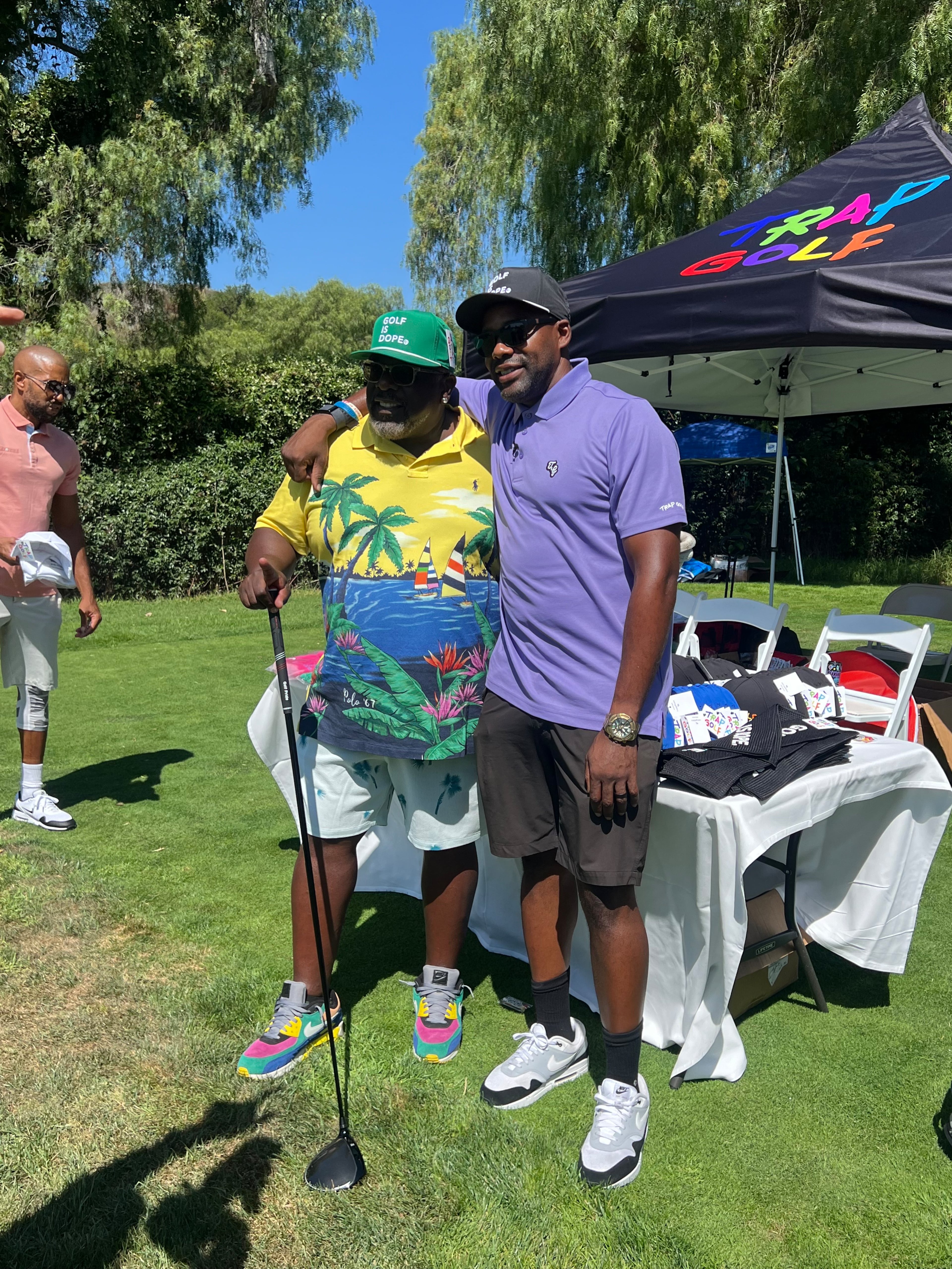 Comedian Cedric the Entertainer (left) sports a Trap Golf cap while posing with Trap Golf co-founder Wayne Birch. (Courtesy Trap Golf)