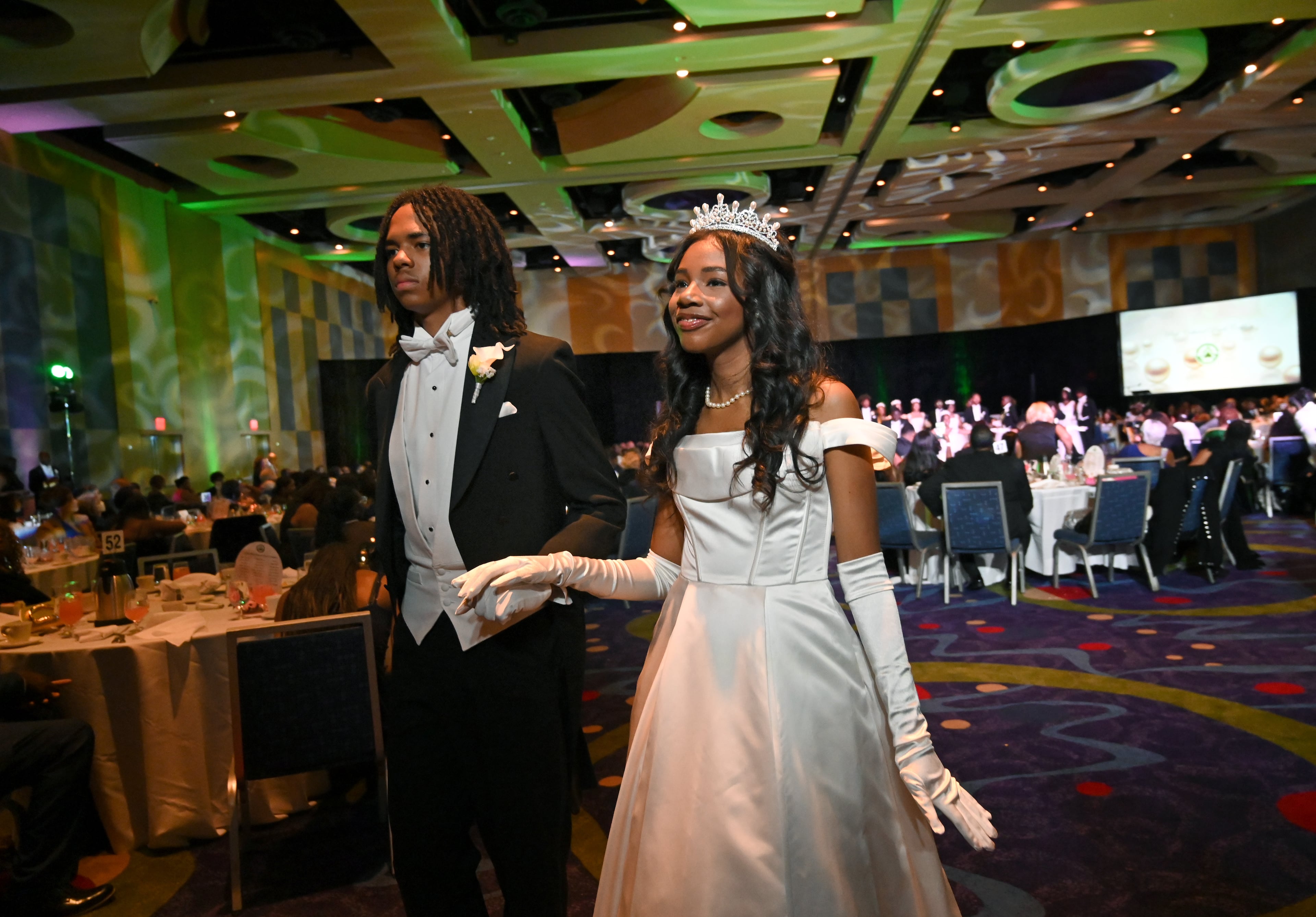 Debutante Yolanda Renee King is escorted by Brandon Coleman during the 2026 Pink Cultured Pearls Cotillion. (Hyosub Shin/AJC)