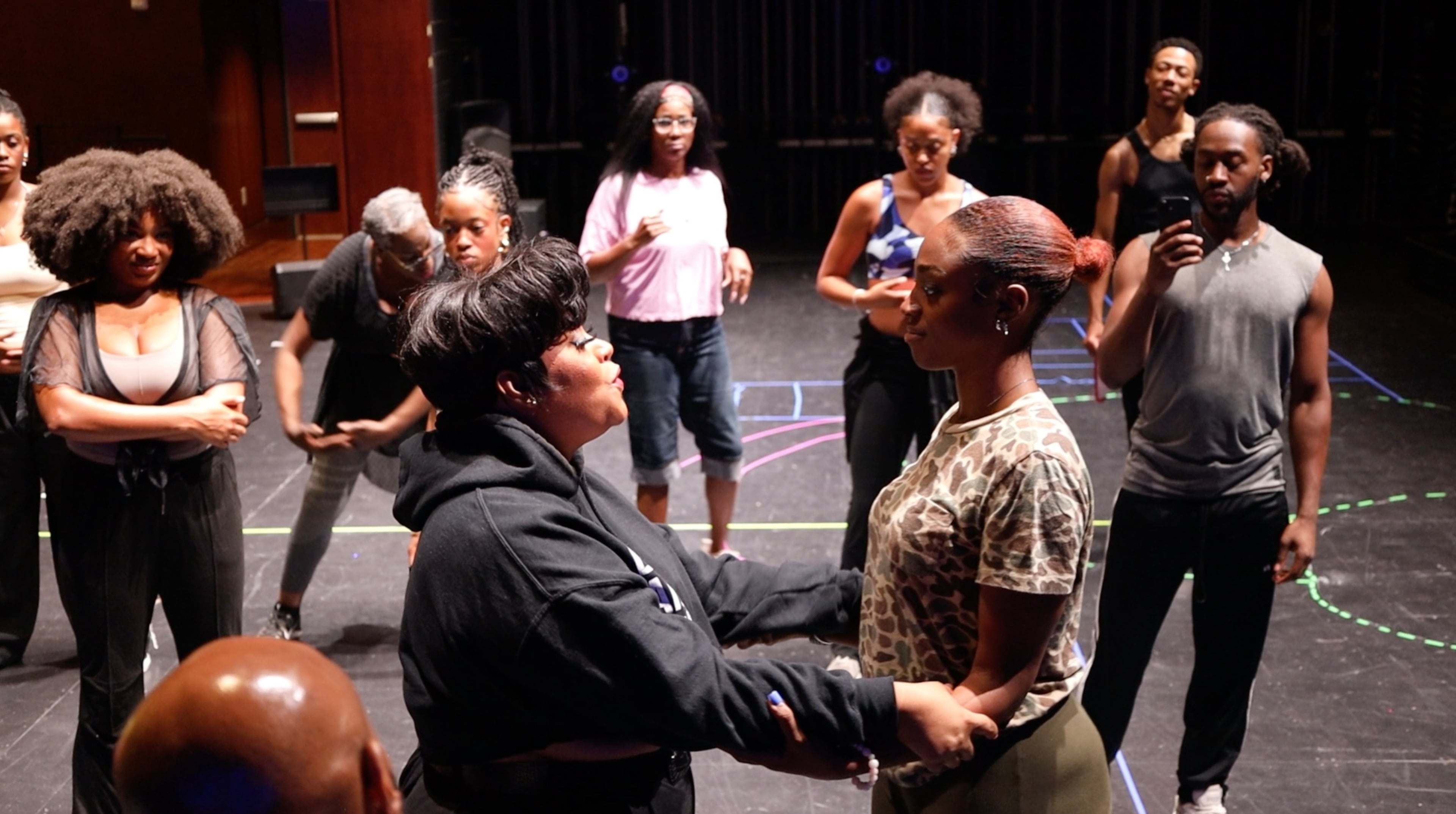 Jai’Len Josey (right), who plays Cinderella in the musical "Cinderella," receives instructions during rehearsals. (Courtesy of True Colors Theatre Company)