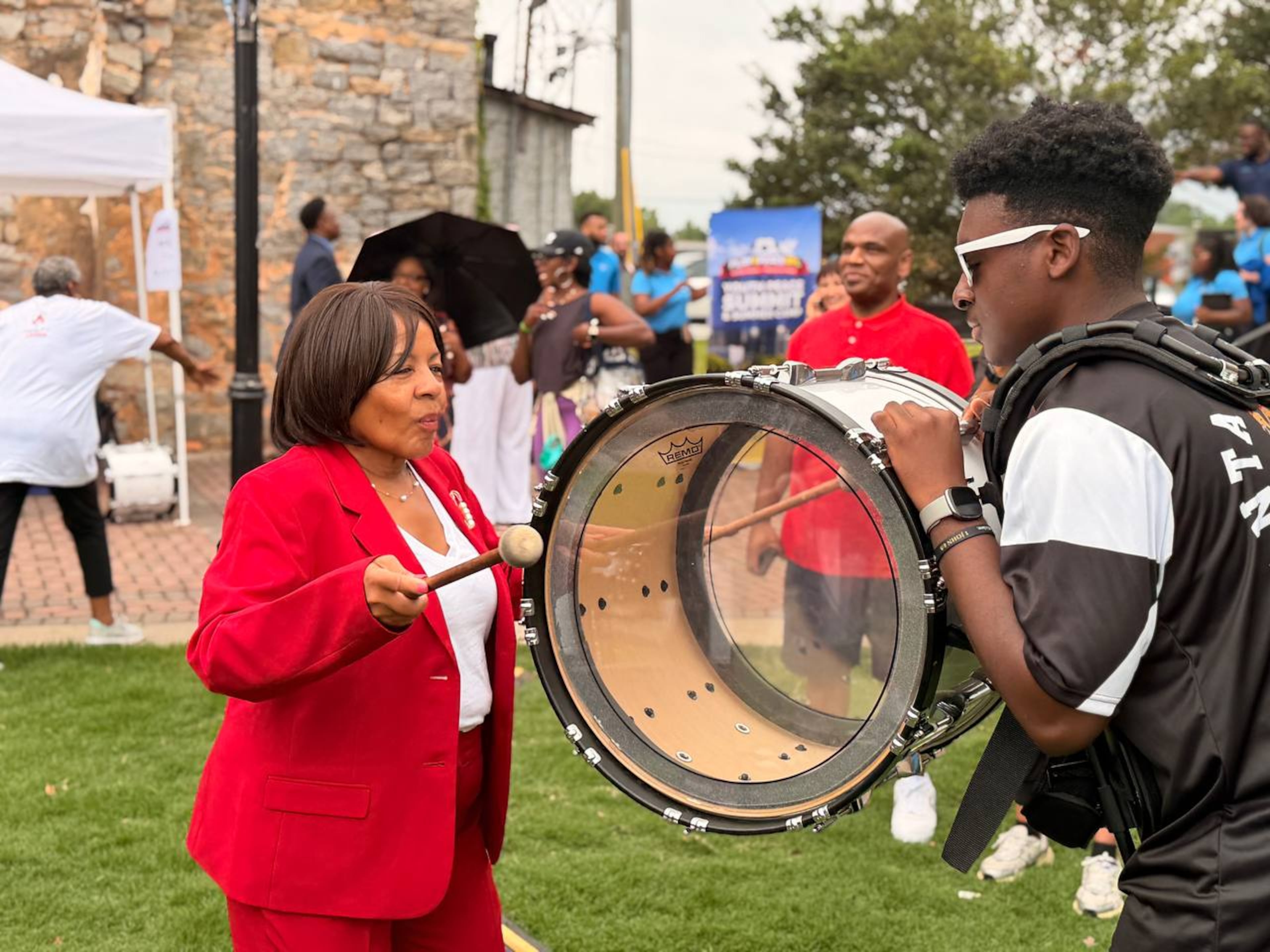 Mayor of Fairburn Hattie Portis-Jones playing a bass drum at the opening ceremony of Play4Peace. (Courtesy of HWPL Georgia)