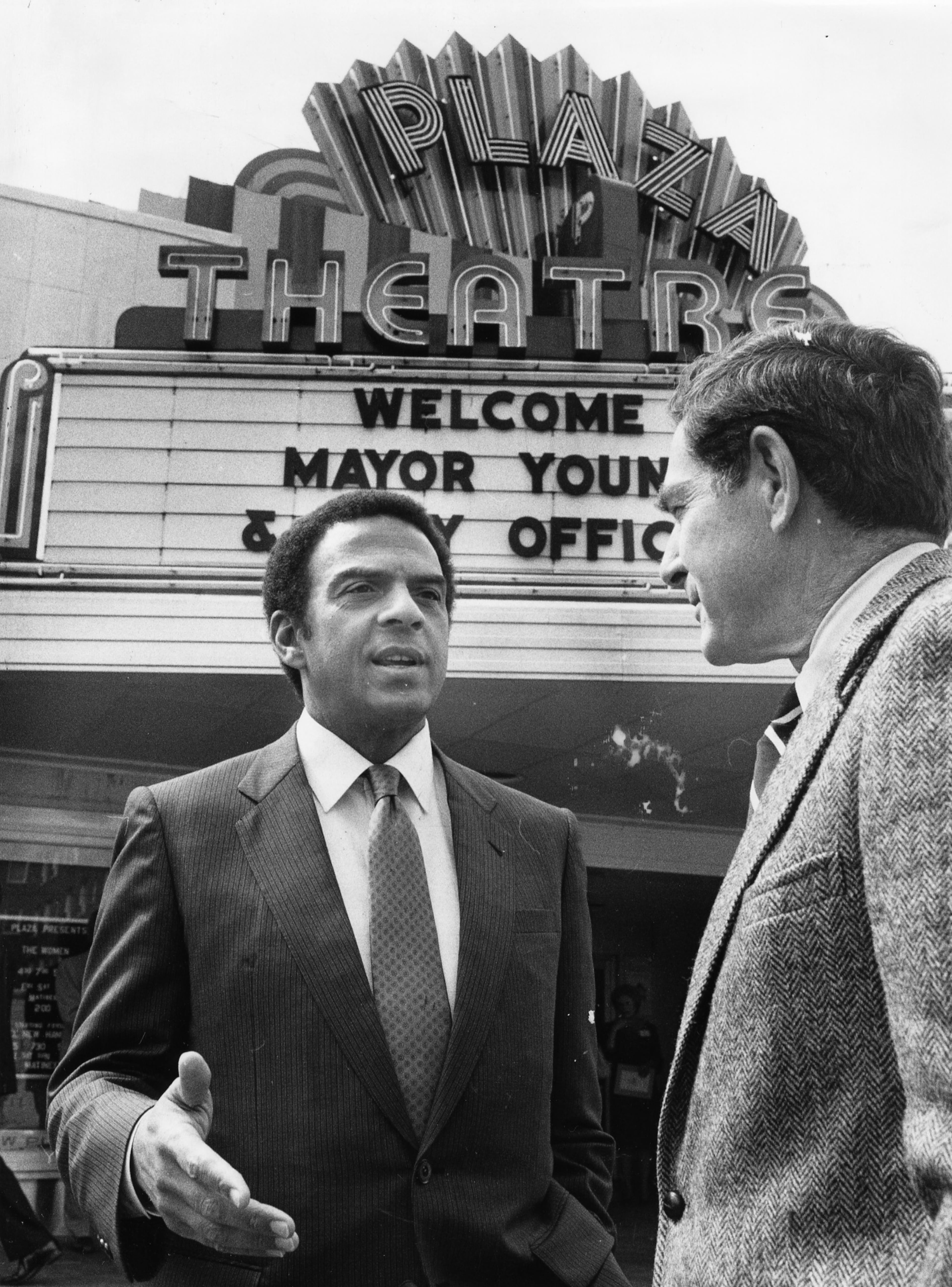 A March 1984 photo of Atlanta Mayor Andrew Young talking to the owner of the Briarcliff Plaza shopping center, Robert S. Griffith Jr., about restoration of the shopping center. They are standing in front of the marquee of the Plaza Theatre. (Steve Deal/AJC file photo)