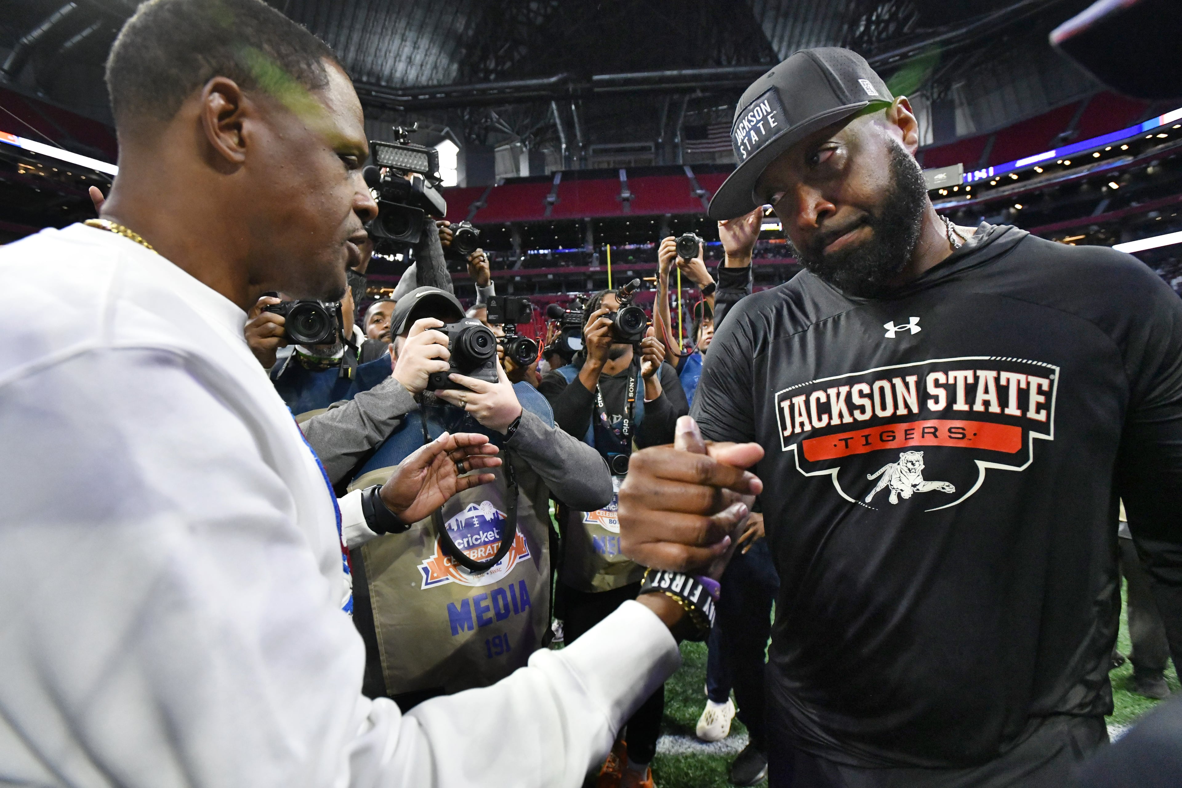 South Carolina State head coach Chennis Berry and Jackson State head coach T.C. Taylor shake hands after Jackson State won last year's Cricket Celebration Bowl. (Hyosub Shin/AJC 2024)