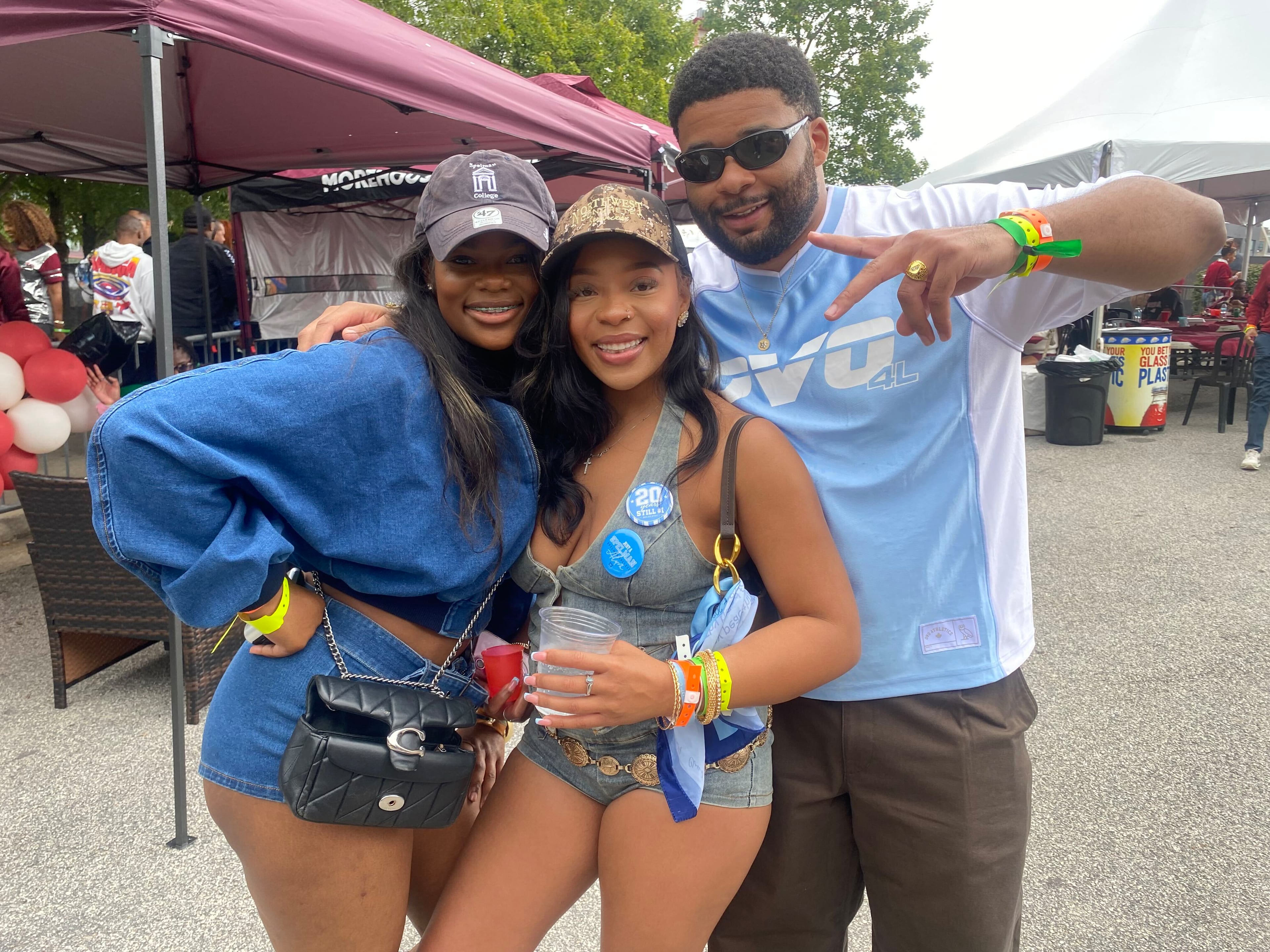 Spelman College class of 2024 alumna Ariana Williams celebrates homecoming with friends (left) Kaiyah Lindley and (right) Morehouse College 2024 alumnus Cornell Robinson. (Brooke Leigh Howard/AJC)