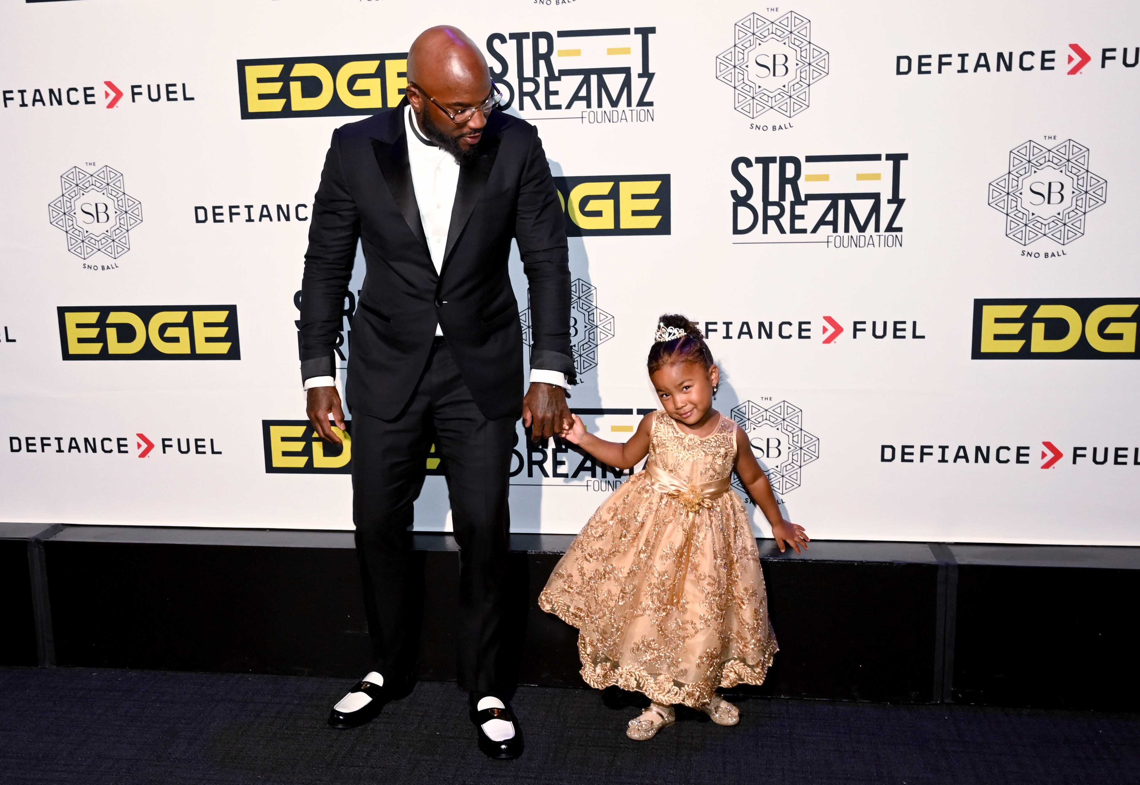 Jeezy and his daughter Monaco Jenkins, 3, poses for photographers upon arrival at the Sno Ball gala. (Hyosub Shin/AJC)