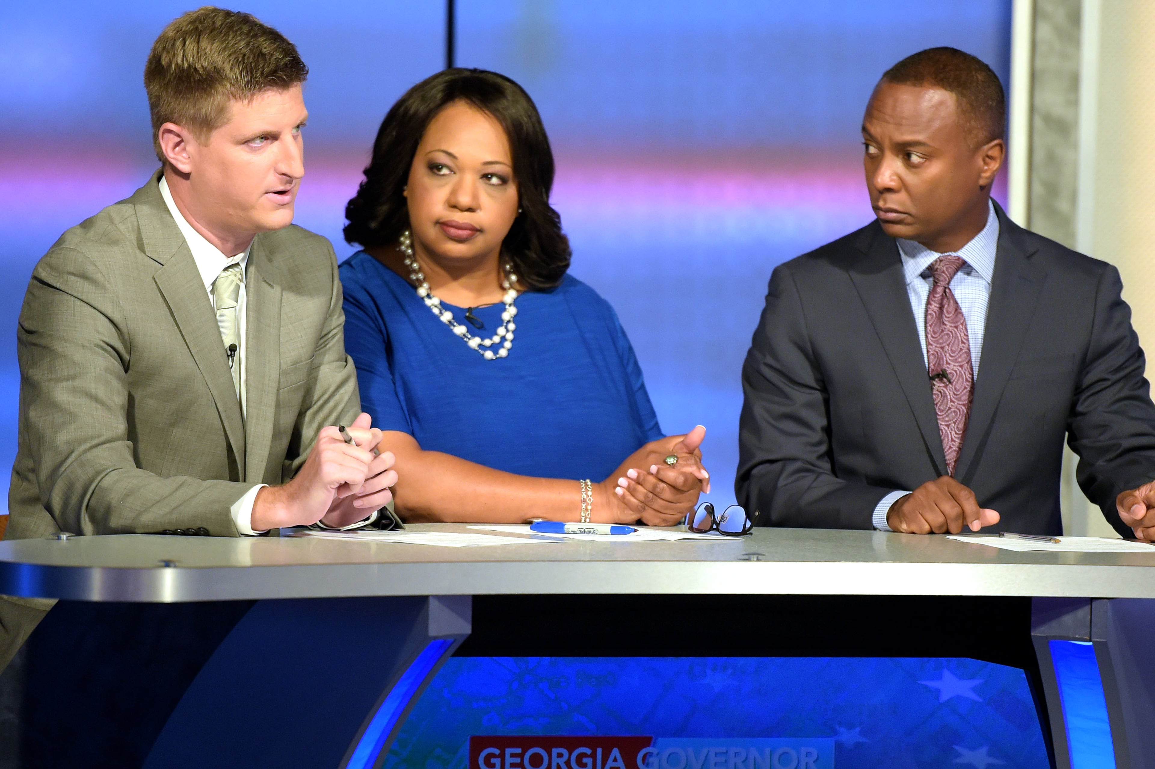 The Atlanta Journal-Constitution political reporter Greg Bluestein, left, asks Lt. Gov. Casey Cagle and Secretary of State Brian Kemp a question at the second and final televised debate at a Channel 2 Action News studio on Sunday, July 15. Bluestein sits on a panel with WSB Radio program operations manager Condace Pressley, middle, and Channel 2 Action News anchor/reporter Dave Huddleston, right. The runoff to decide the Republican candidate for governor will be held July 24. (Jenna Eason /AJC file photo)