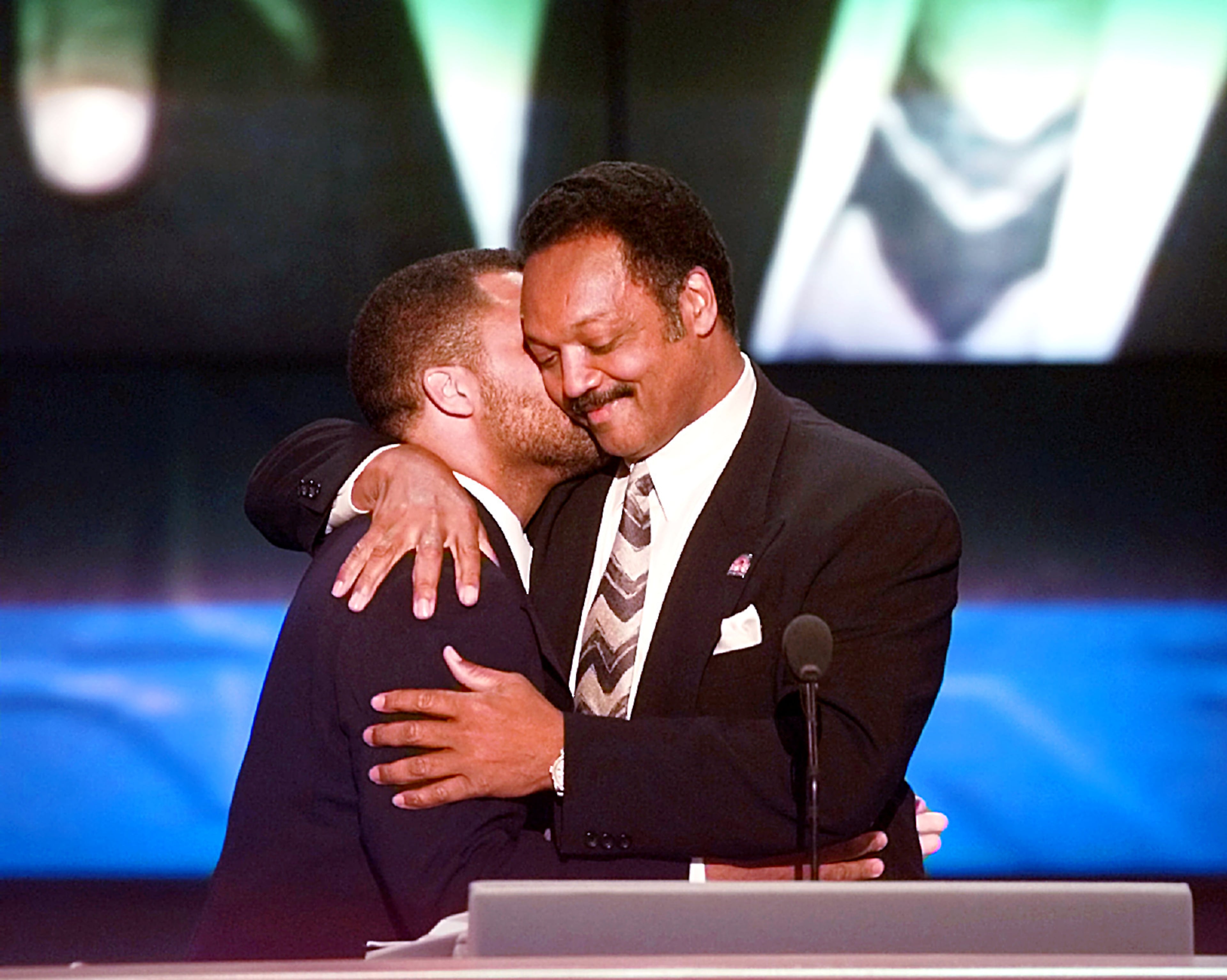 Rev. Jesse Jackson hugs his son Jesse Jackson Jr. after being introduced to speak to delegates at the United Center Tuesday, Aug. 27, 1996, in Chicago during the Democratic National Convention. (Ron Edmonds/AP)