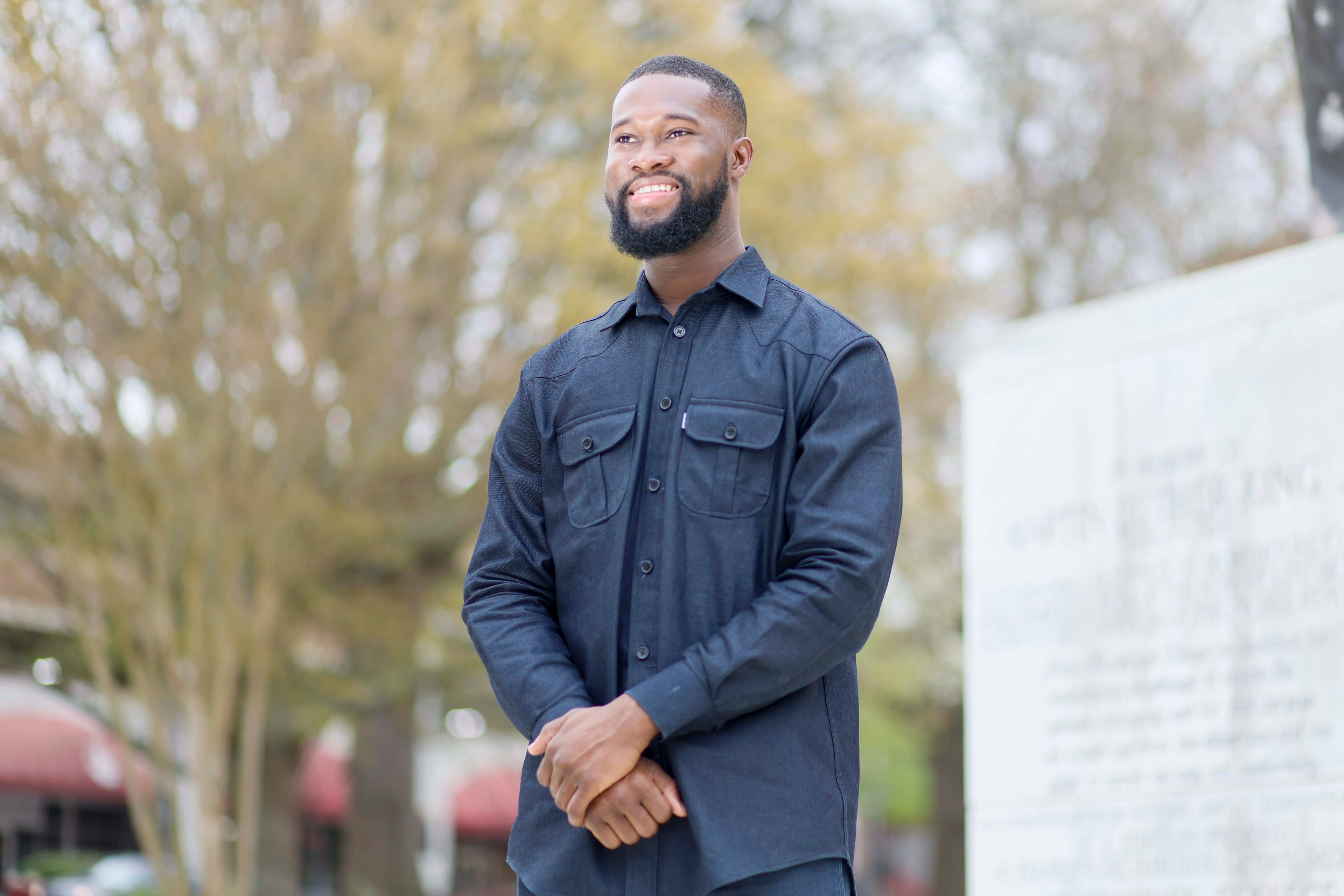 Rhodes Scholar Aniaba Jean-Baptiste N’Guessan poses next to the Martin Luther King Jr. statue at the MLK International Chapel at Morehouse College. (Miguel Martinez/AJC)