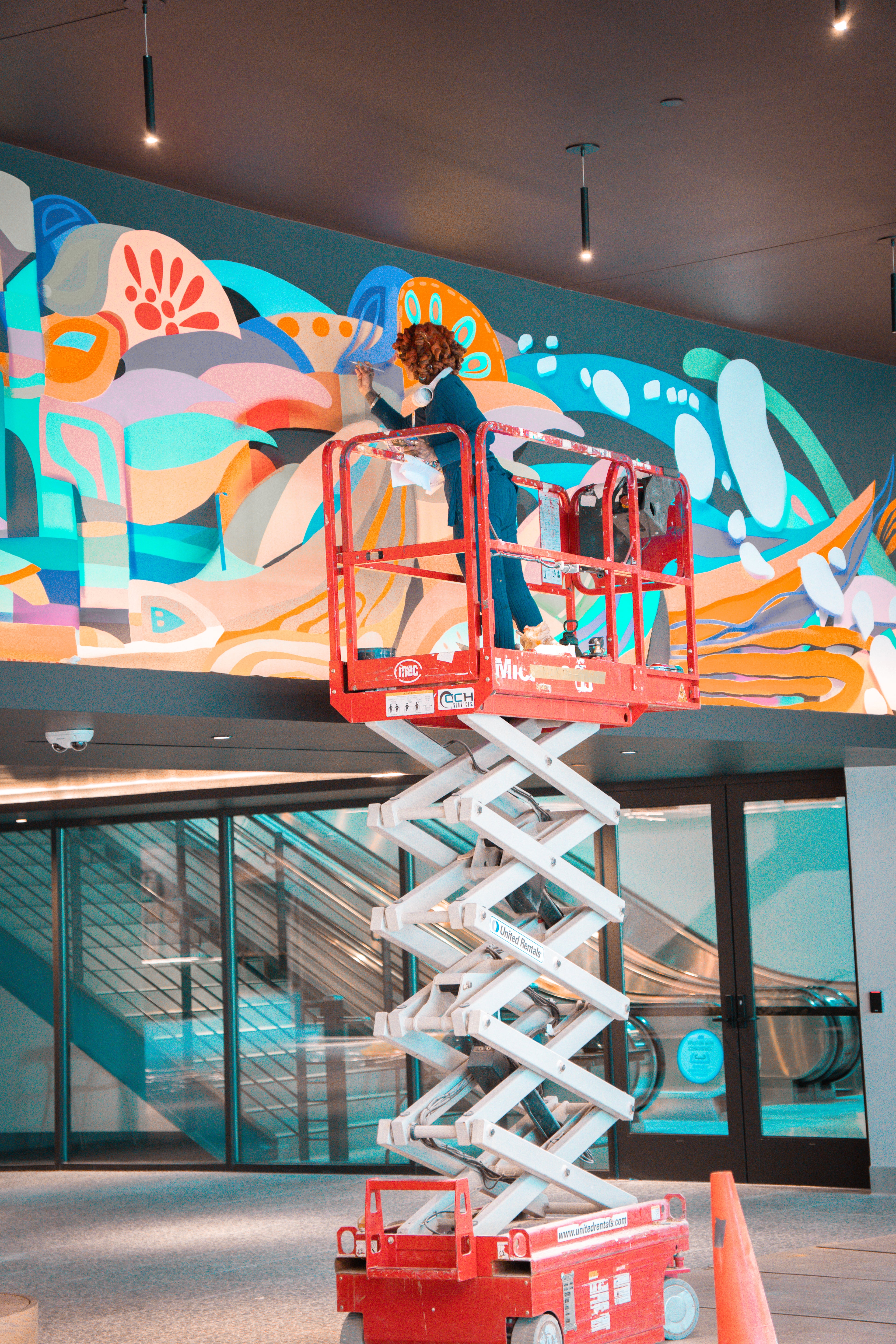 Charity Hamidullah paints the "Revival" mural for the installation at The CTR. Hamidullah is an Atlanta artist being highlighted for UATL's 404ward series, with the current focus on the performing and creative arts. (Photo by Angel Parrilla)