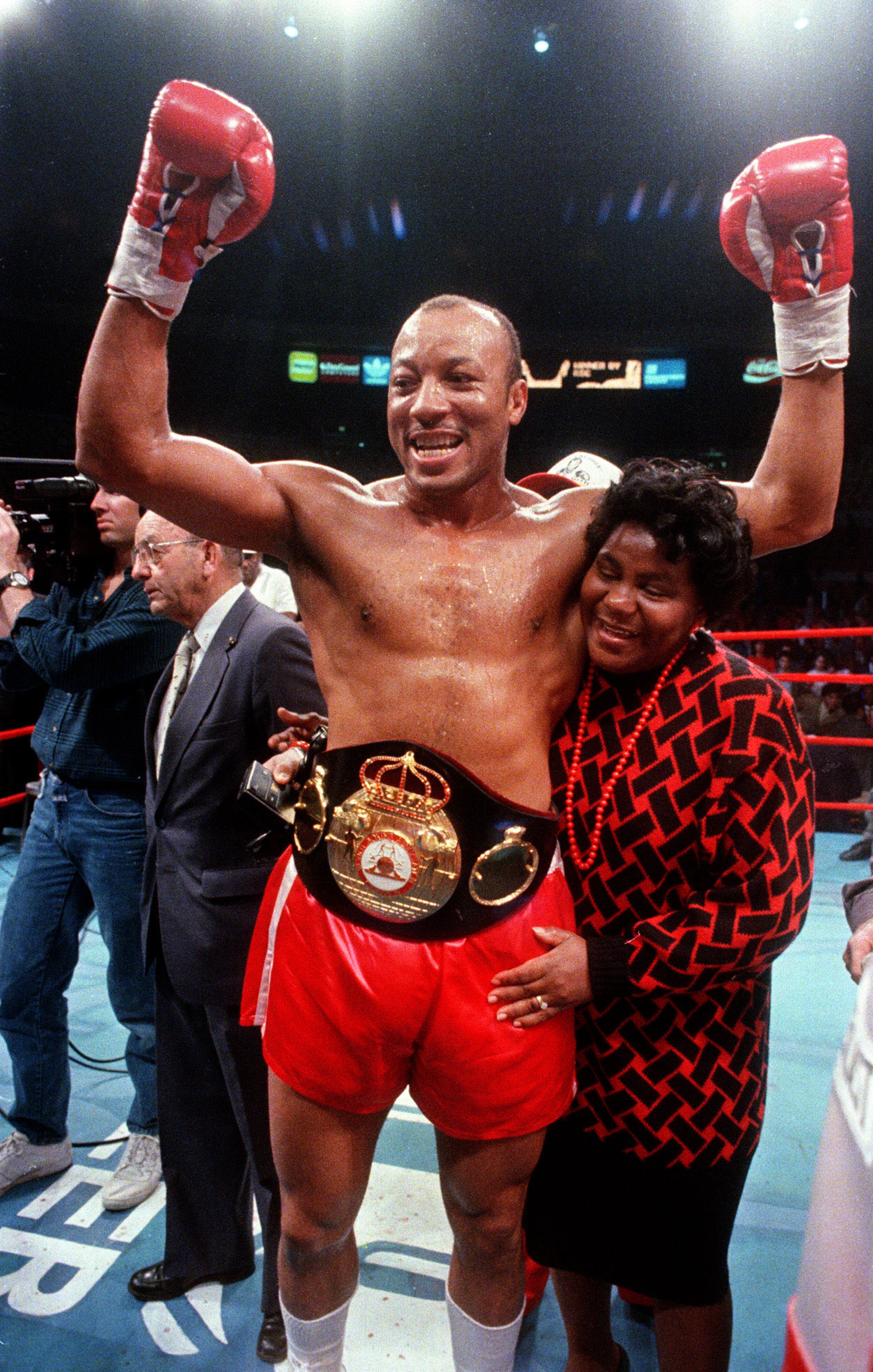 James "Bonecrusher" Smith gets a hug from his wife Reba after defeating Tim Witherspoon in the first round to win the World Boxing Association's heavyweight championship, Dec. 13, 1986, in New York. Smith is perhaps the only professional champ with a college degree. (Wilbur Funches/AP)