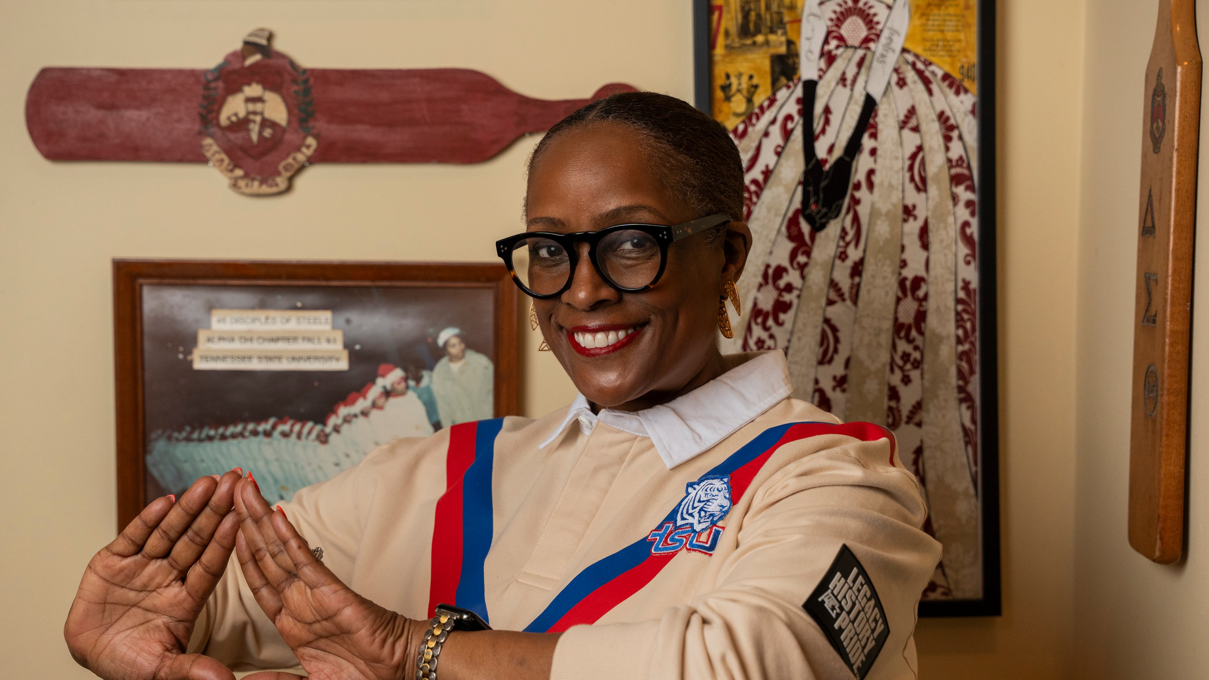 Latise Egeston forms the delta hand sign of Delta Sigma Theta Sorority, Inc. at her Stone Mountain home on Friday, Sept. 18, 2026. She joined the sorority's Alpha Chi Chapter at Tennessee State University. (Olivia Bowdoin for the AJC)