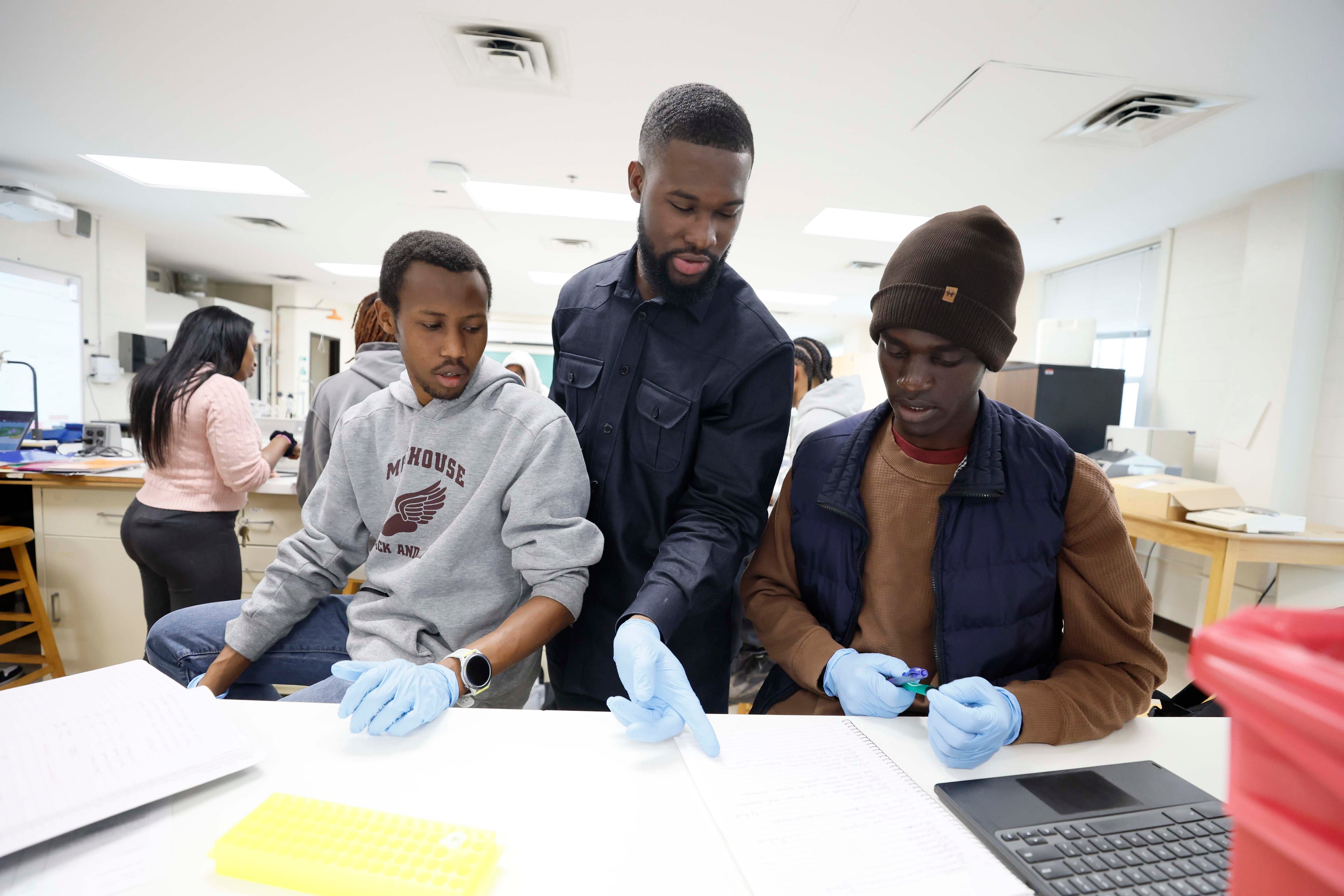 Rhodes Scholar Aniaba Jean-Baptiste N’Guessan, center, participates in a class with teammates Brian Kemei, left, and Victor Shebii in the Cell and Molecular Biology Lab at Morehouse College. (Miguel Martinez/AJC)