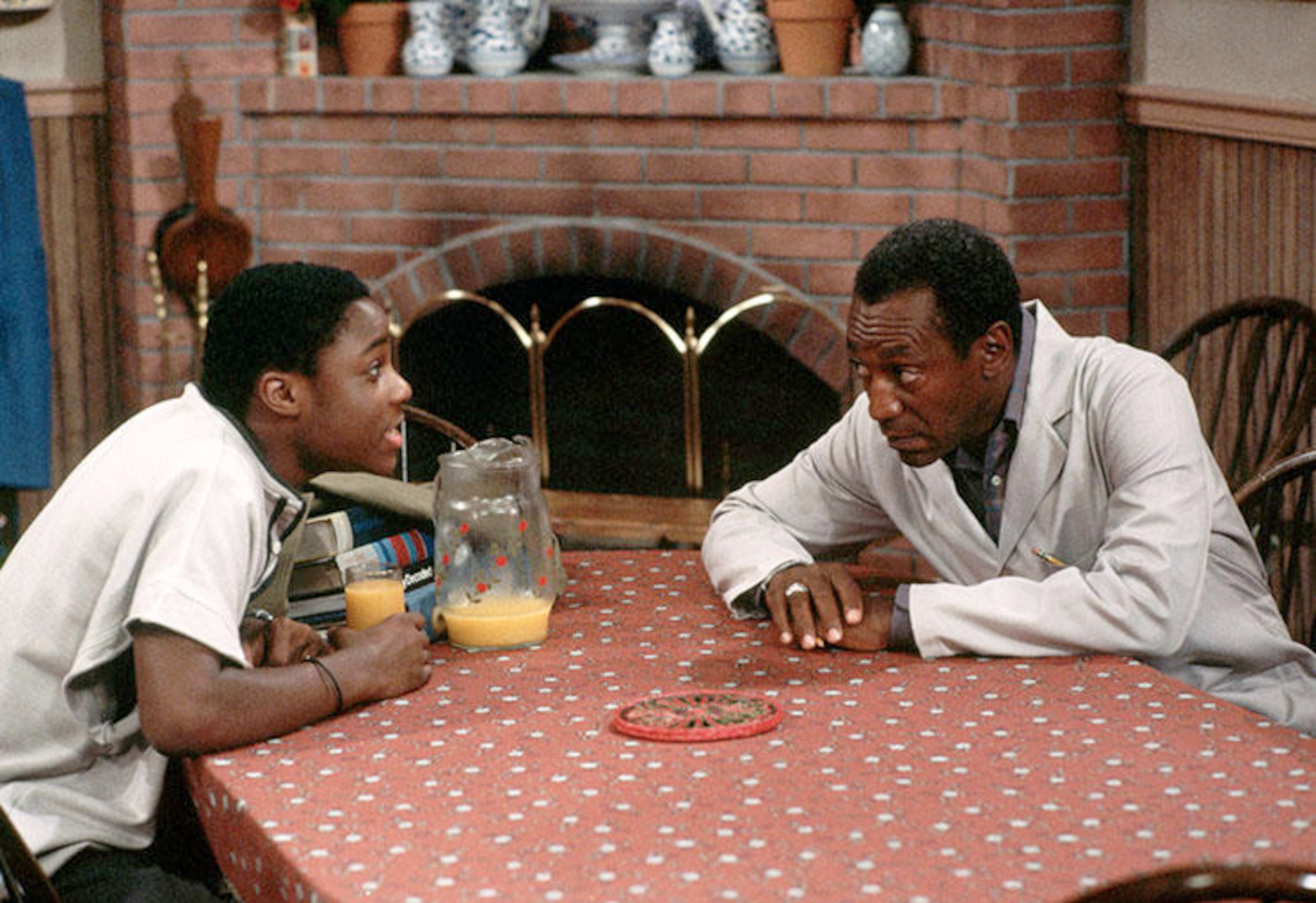 Theo Huxtable, played by Malcolm-Jamal Warner (left), talks with his father, Heathcliff Huxtable — played by Bill Cosby — in an episode of "The Cosby Show." (Jacques M. Chenet/CORBIS 1985)