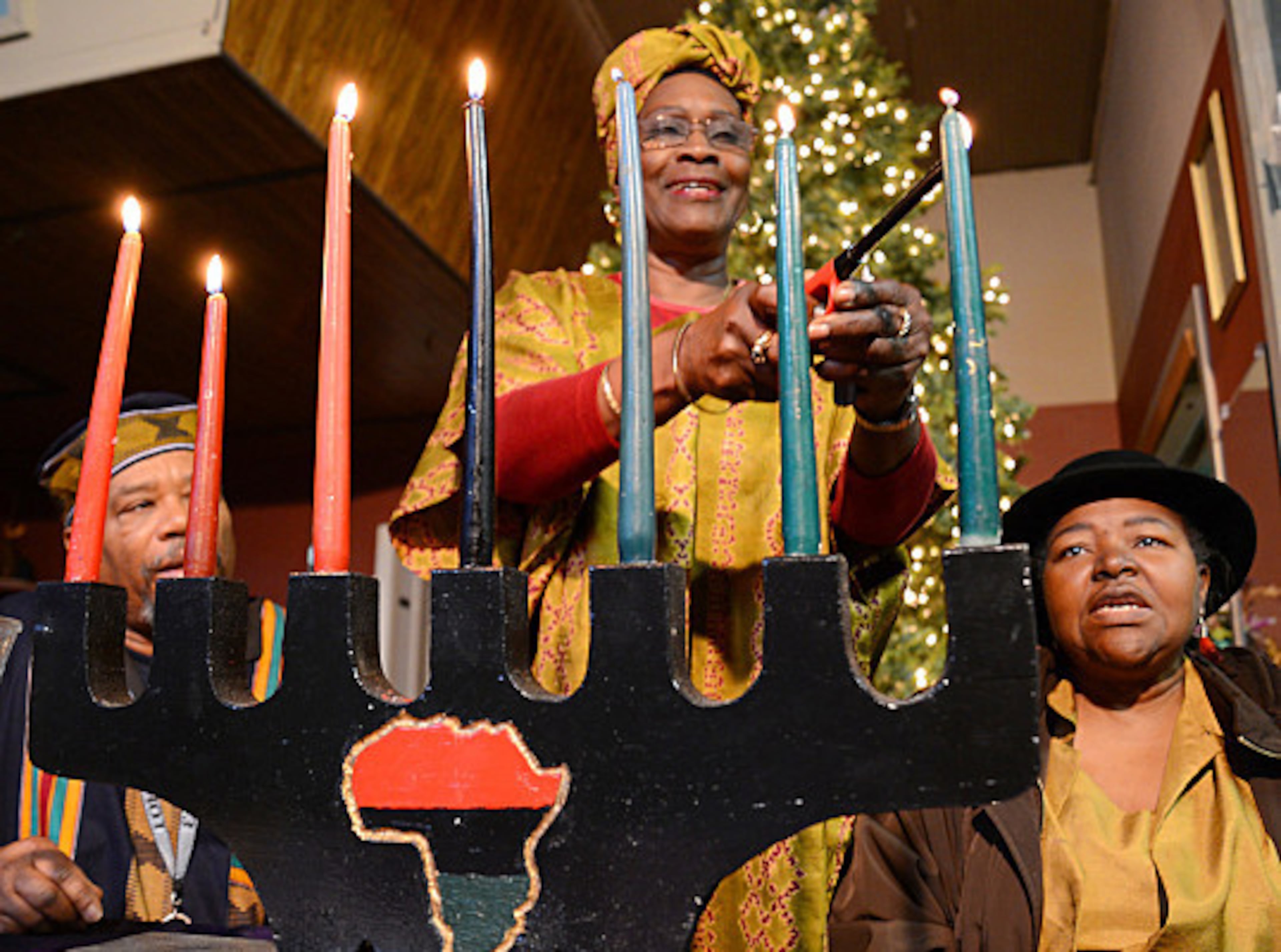 Each night of Kwanzaa, a candle is lit on the “kinara” to symbolize one of the principles. The candles — one black, three red, and three green — reflect Pan-African symbolism. (File)