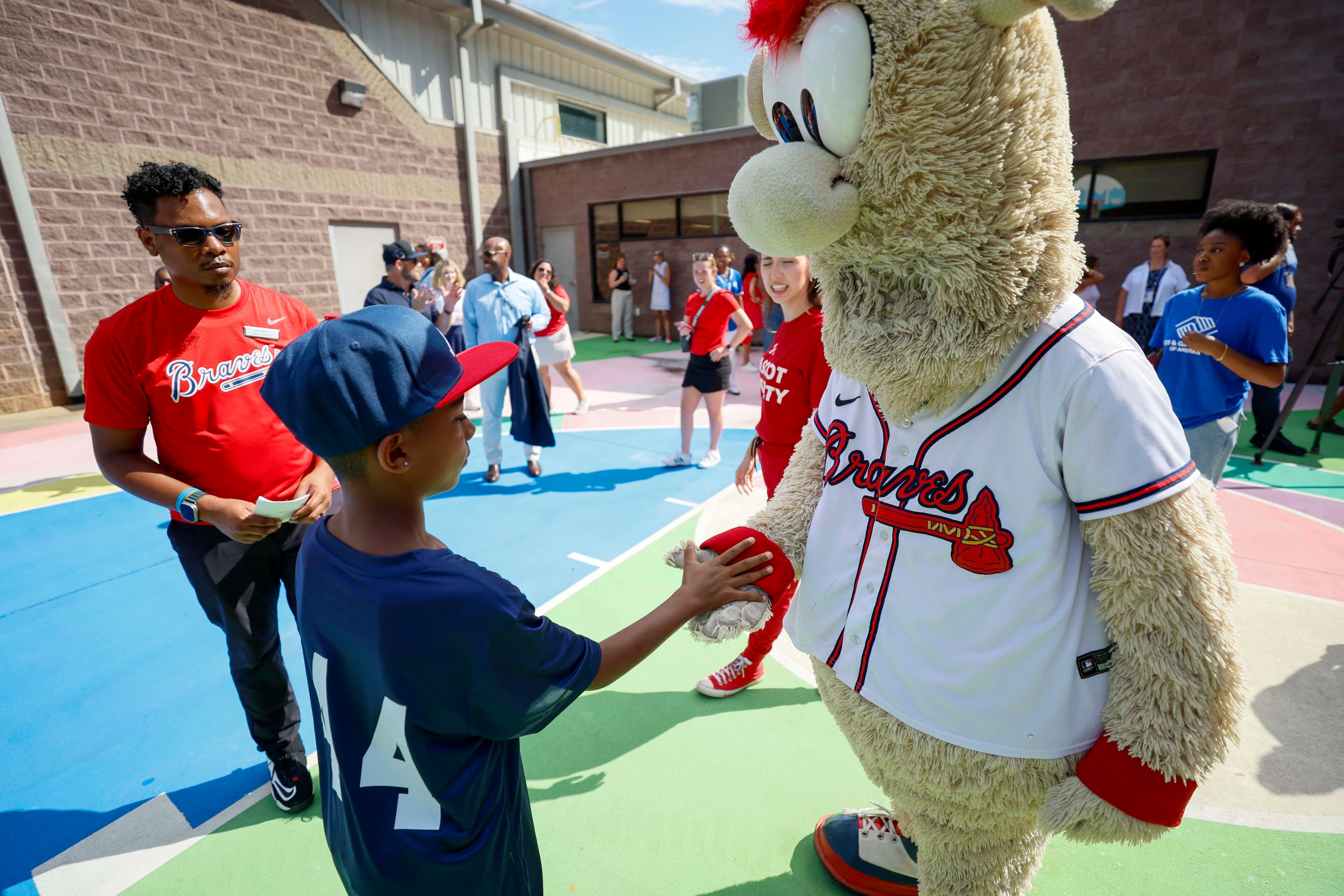 Atlanta Braves mascot Blooper gives a high-five to a kid during the unveiling of the new All-Star Legacy Field at the Barksdale Boys & Girls Club in Conyers on Thursday, July 10, 2025. (Miguel Martinez/AJC)