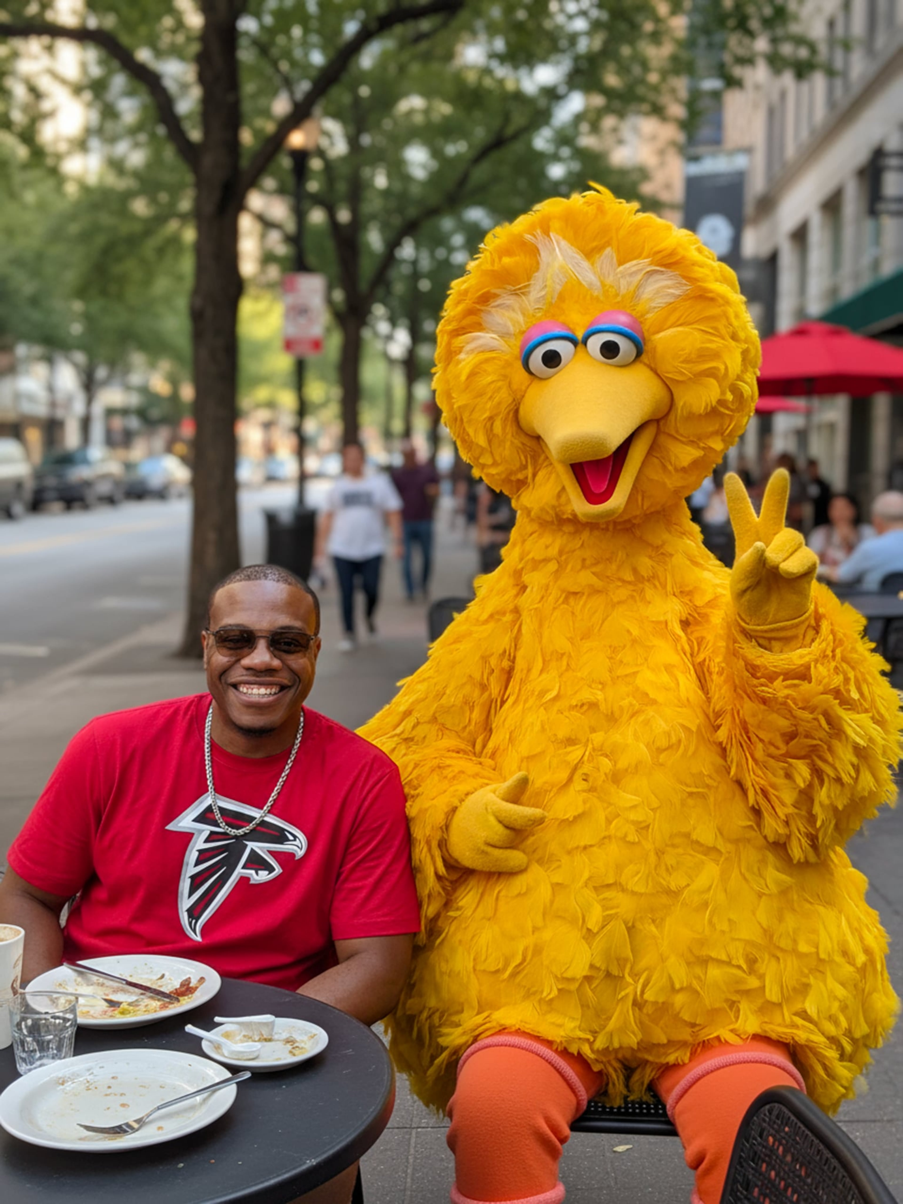 Andre Moore (left), stopped by Sesame Street to have lunch with Big Bird, in one of his viral videos that recapture his youth through images of pop culture.(Courtesy Andre Moore)